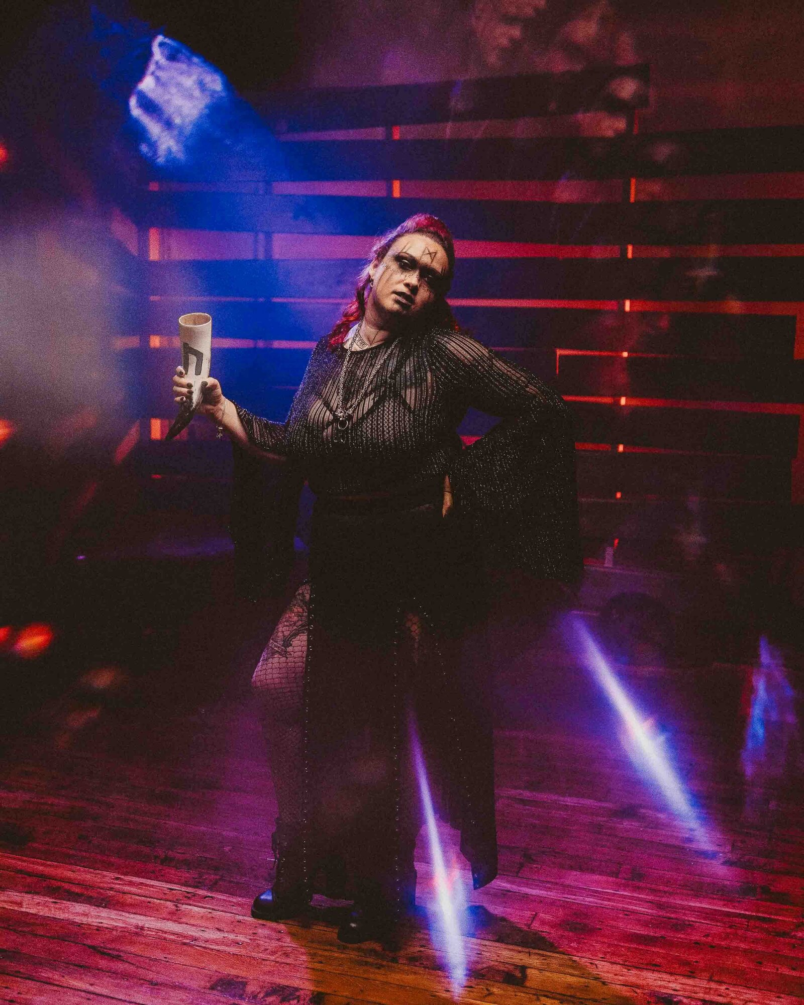 spooky woman holding a horn 