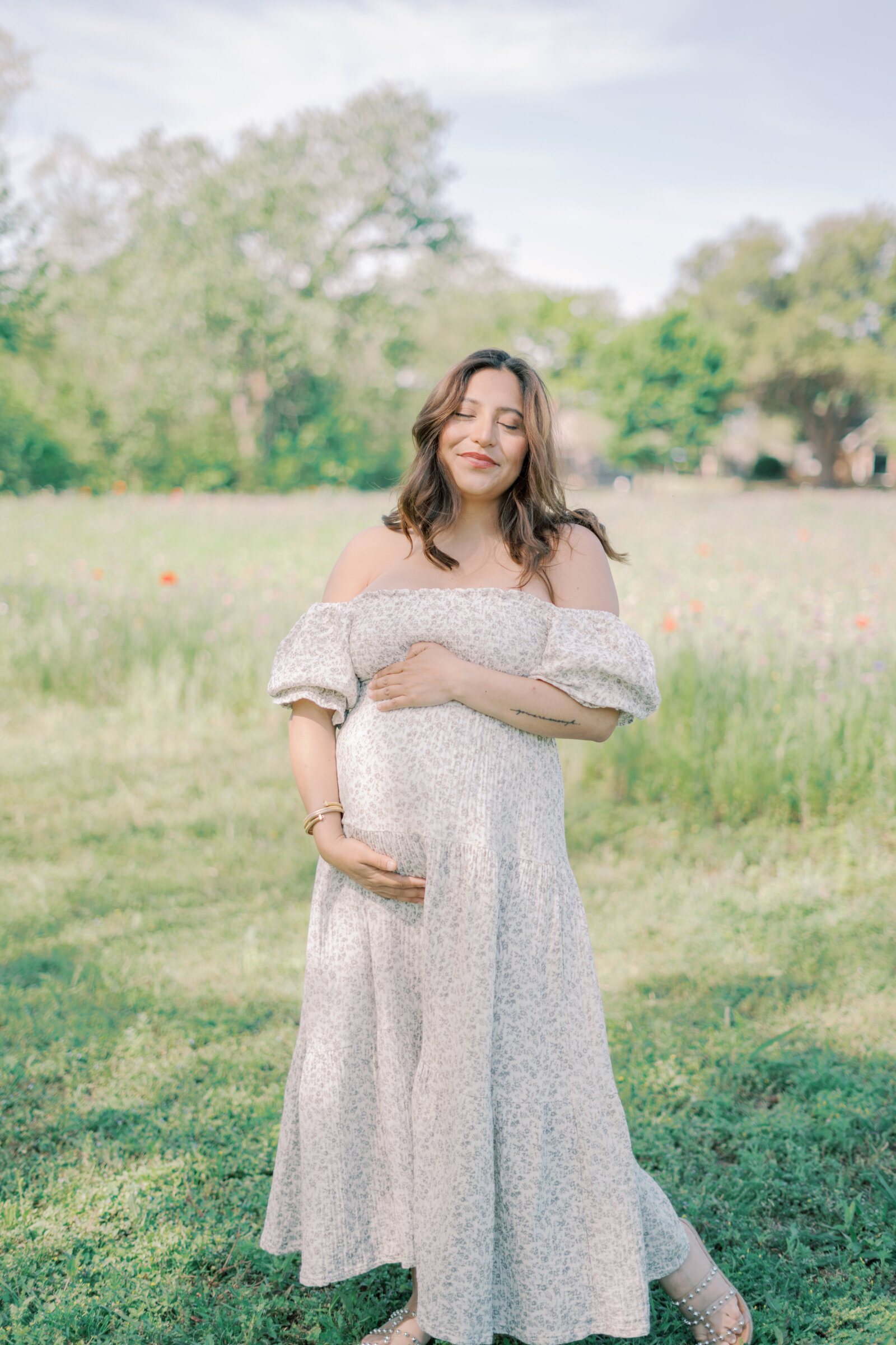 mom with closed eyes hugging her belly