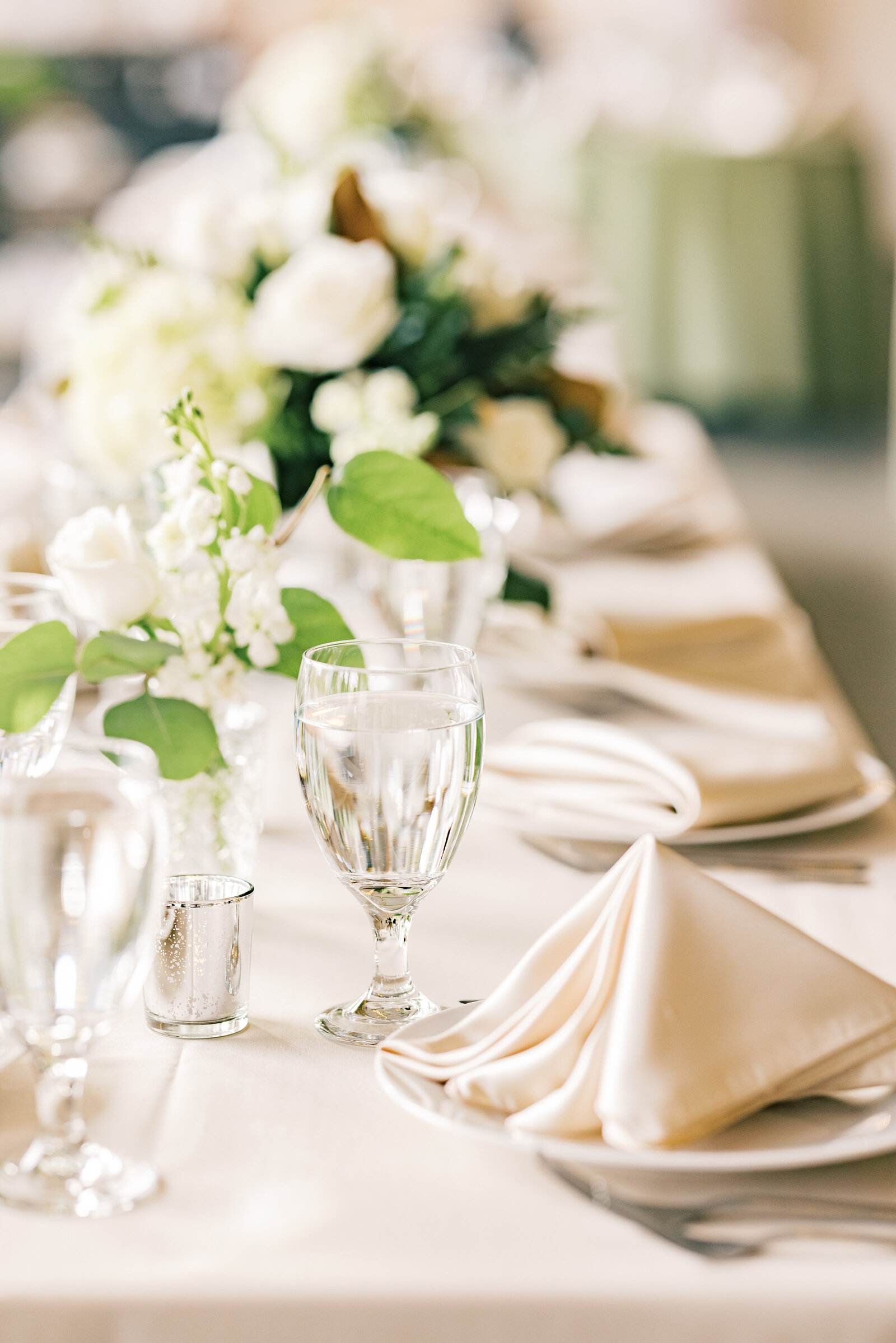Intricate wedding tablescape details at Inola, showcasing lush florals, elegant tableware, and a perfectly curated ambiance for a timeless event