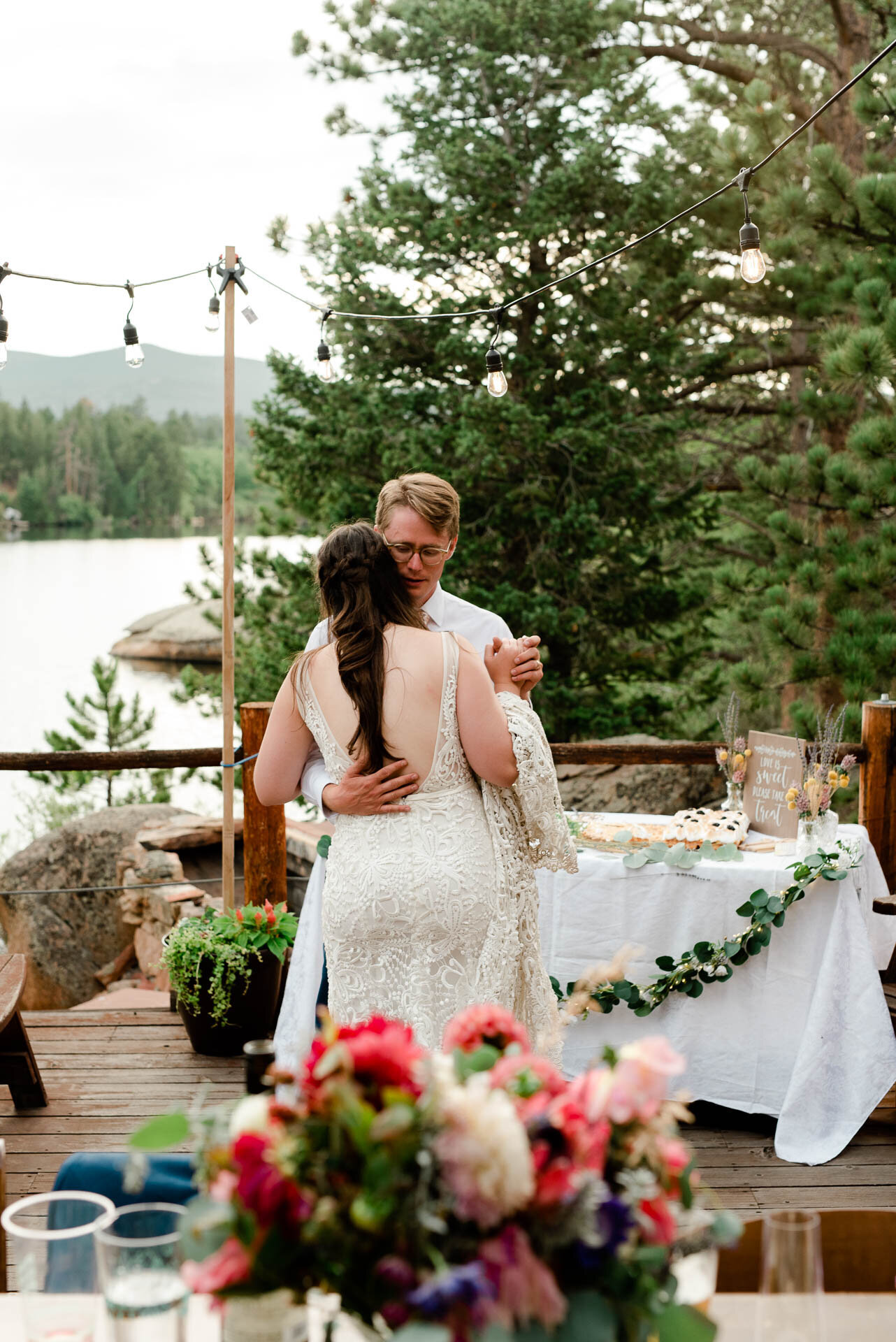 bride and groom dancing at the waters edge in red feather colorado.
