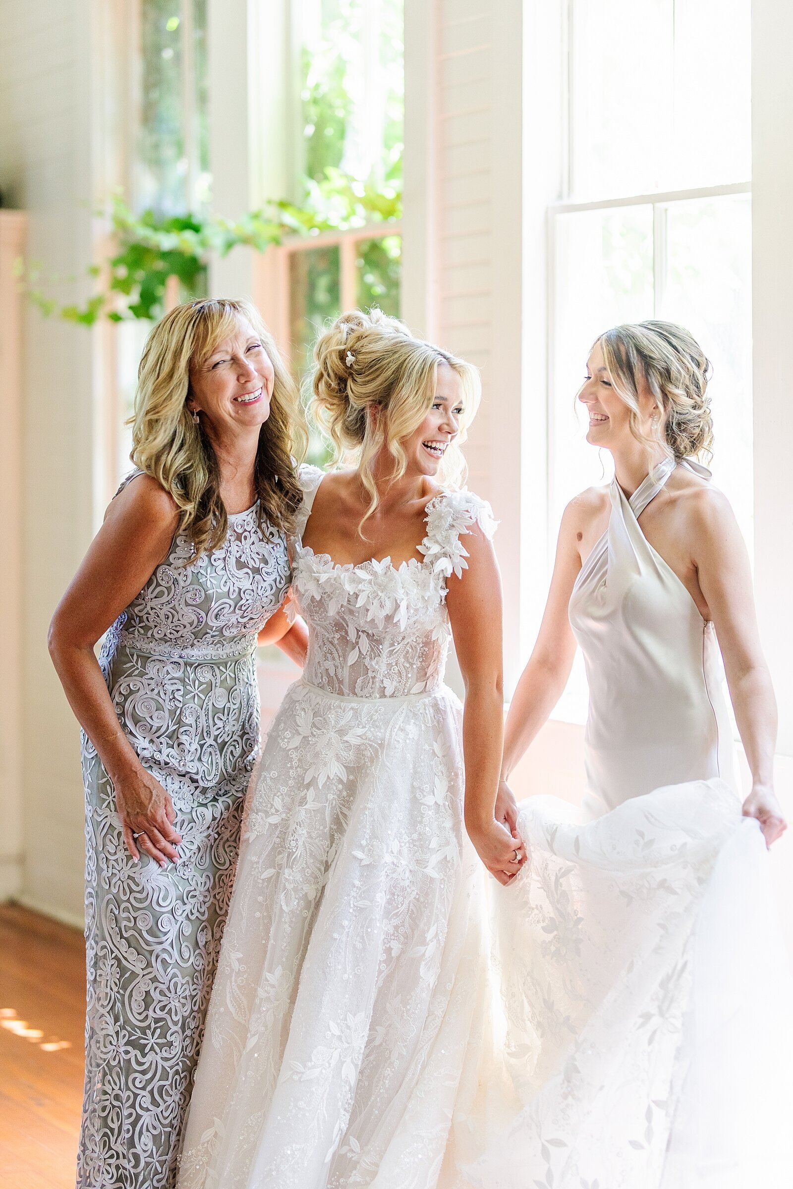 Mom, bride, and maid of honor laughing together at Green Gables Wedding venue in San Marcos in southern California.