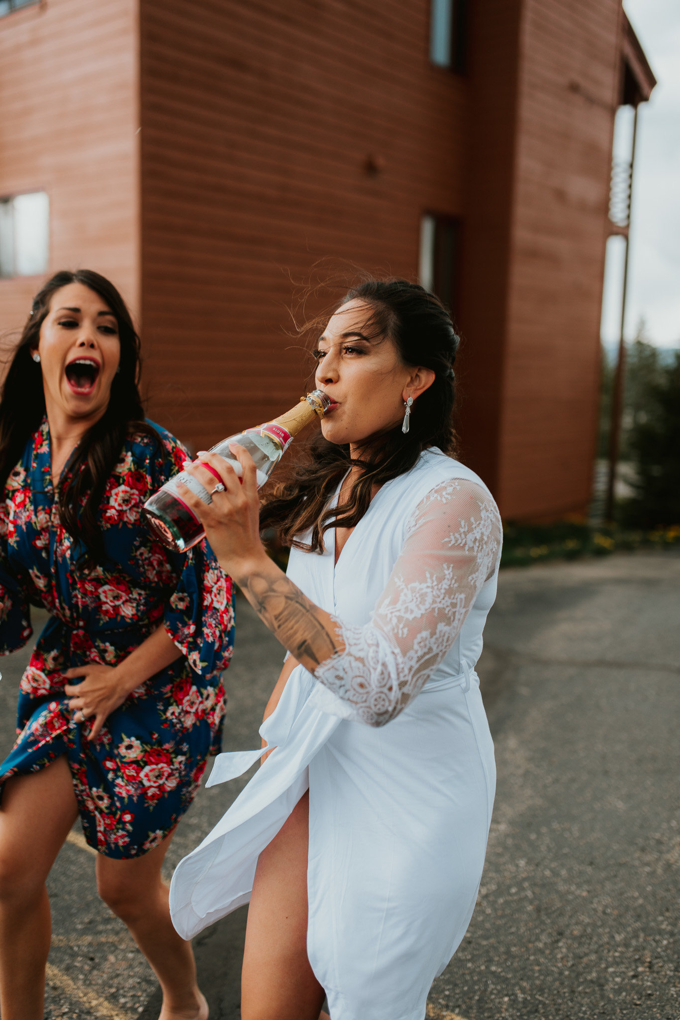 Fun photo of Bride in Breckenridge colorado  drinking out of a bottle. Candid photo.