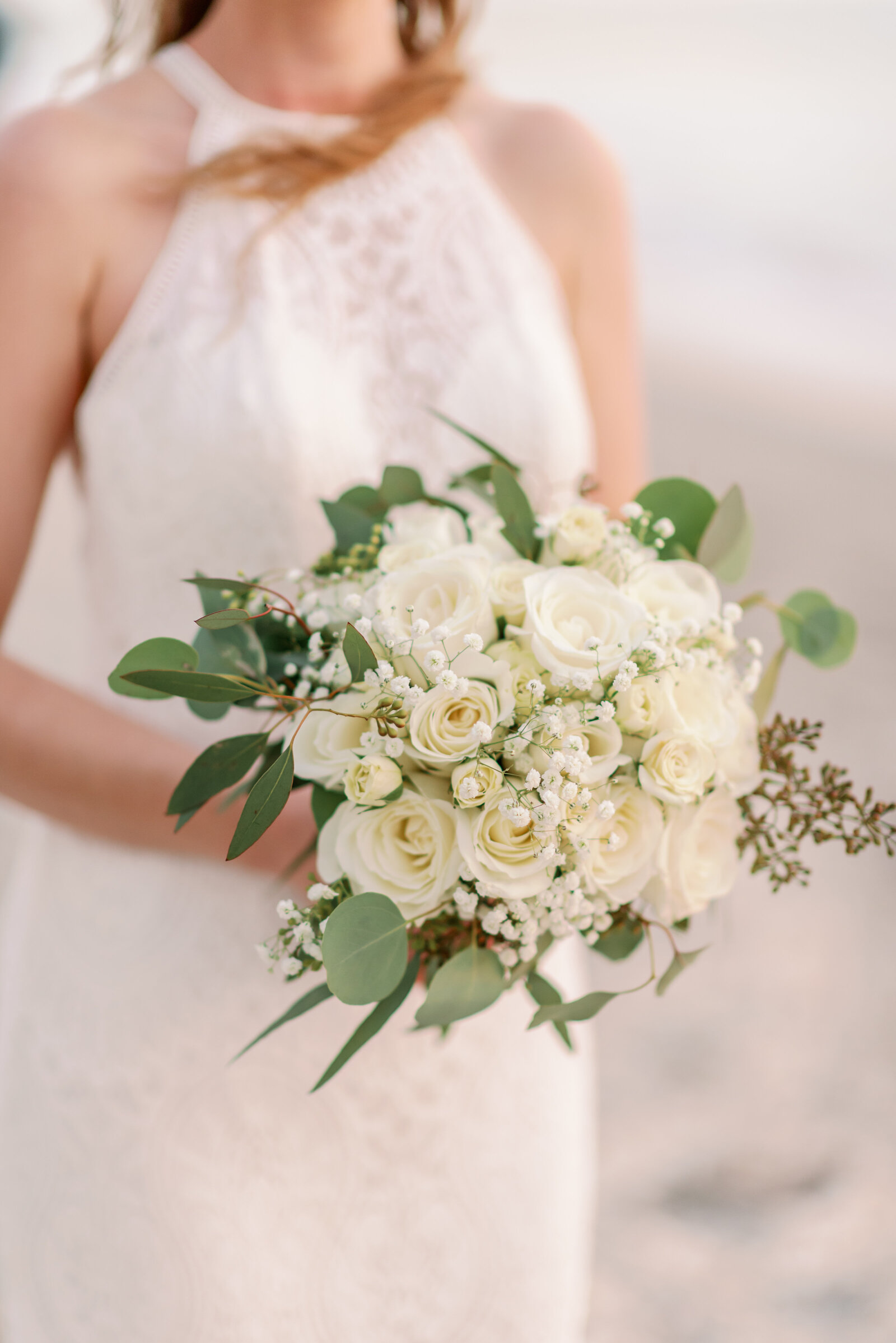 close up of brides bouquet showing white flowers and some greenery