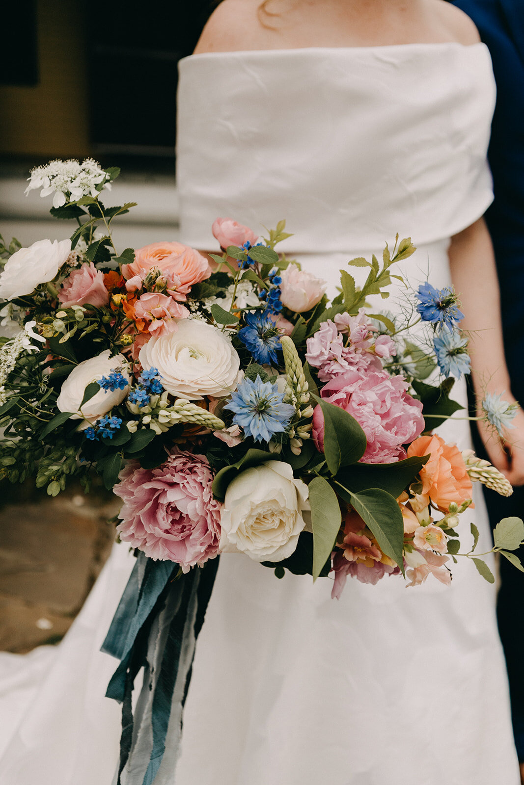 New England bride holding colorful bouquet