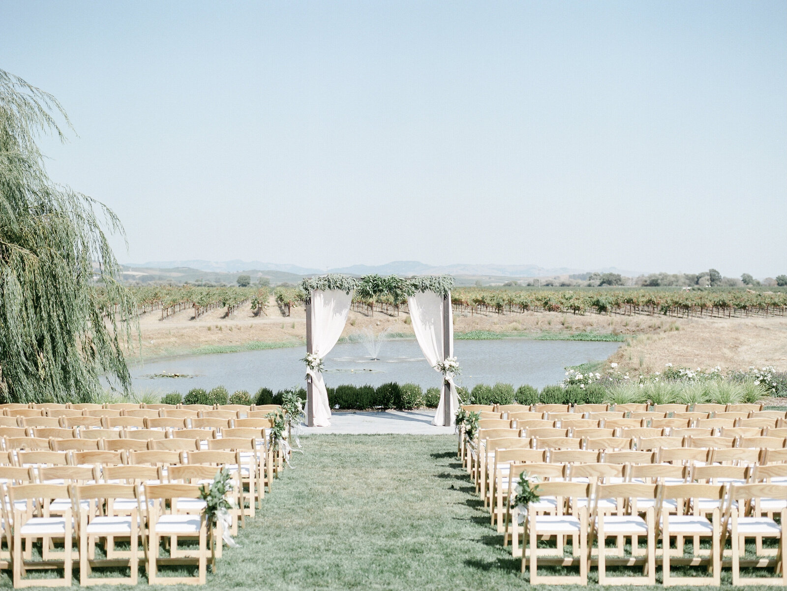 Wedding ceremony venue with arch by a lake