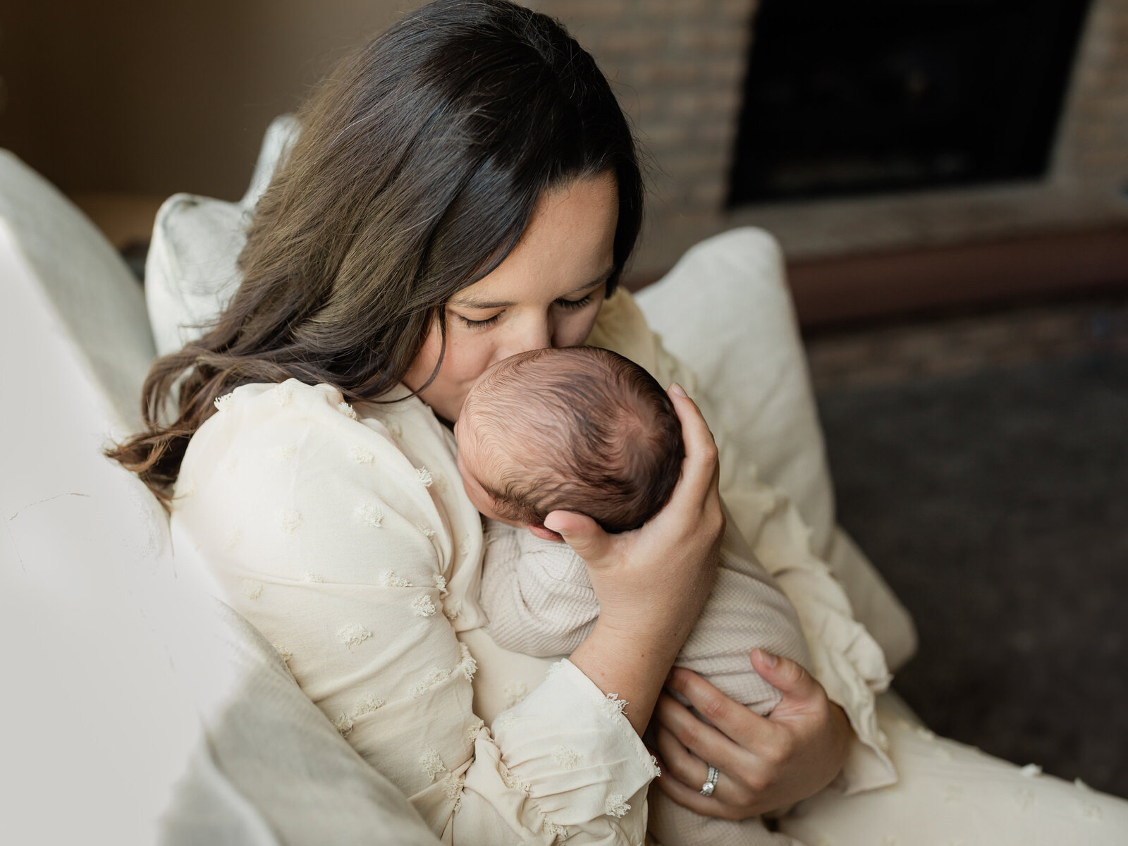 mom kissing newborn baby boy for in home newborn session