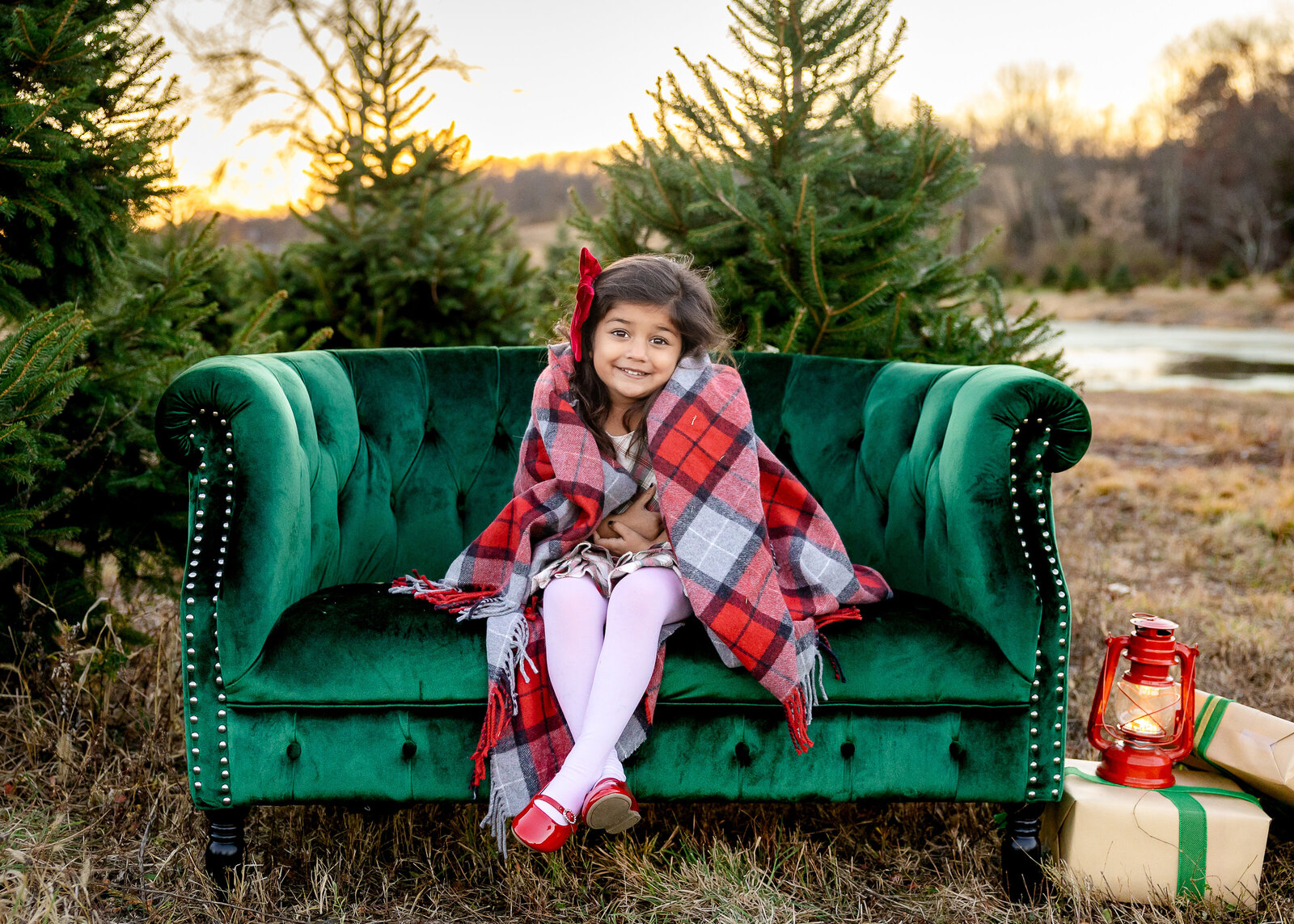 Holiday photo of smiling girl on a couch at a Sussex County, New Jersey Christmas tree farm.