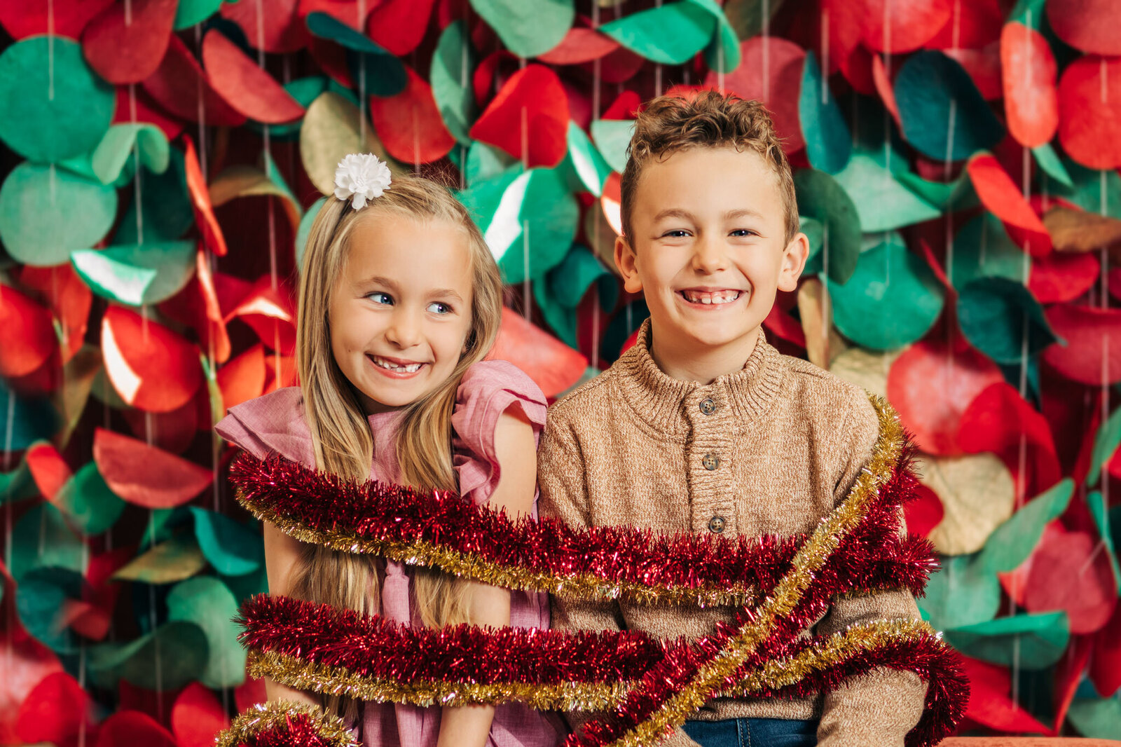 kids-wrapped-in-christmas-garland