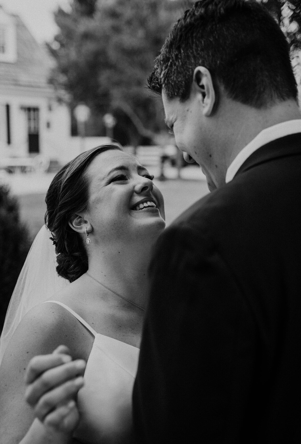 Virginia Wedding Photos of a young couple smiling at each other in a dreamy black and white edit