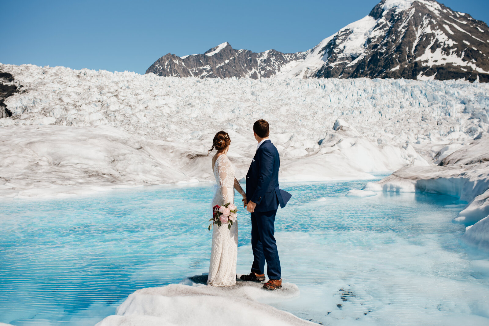 couple standing on knik glacier