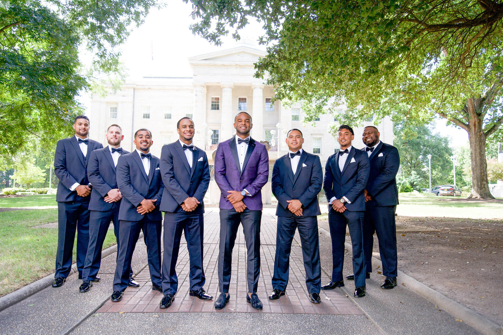 Sharp-dressed groomsmen in navy suits at a luxury Raleigh wedding, planned by a top event planner.