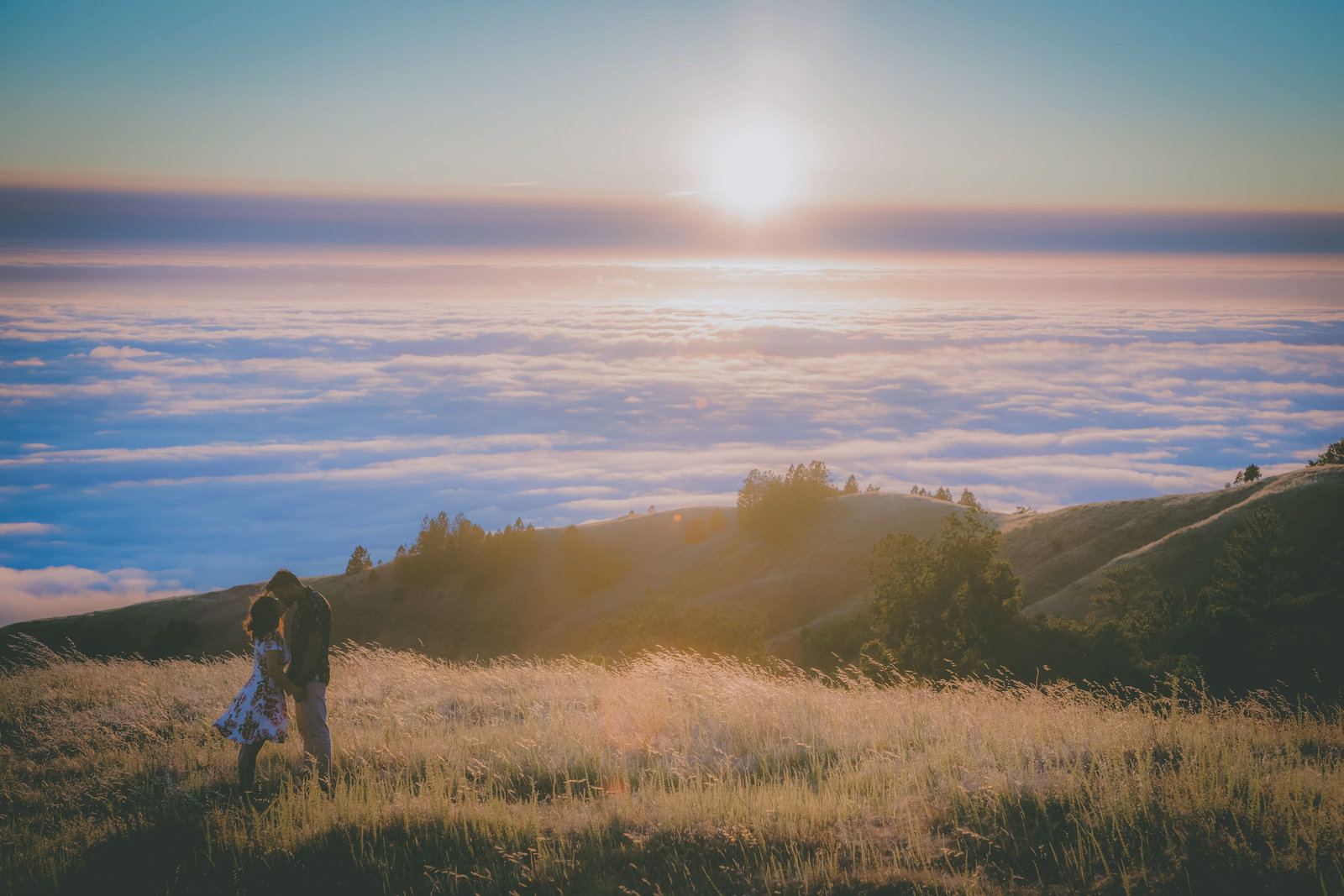 Marine layer rolls into Big Sur with couple kissing.