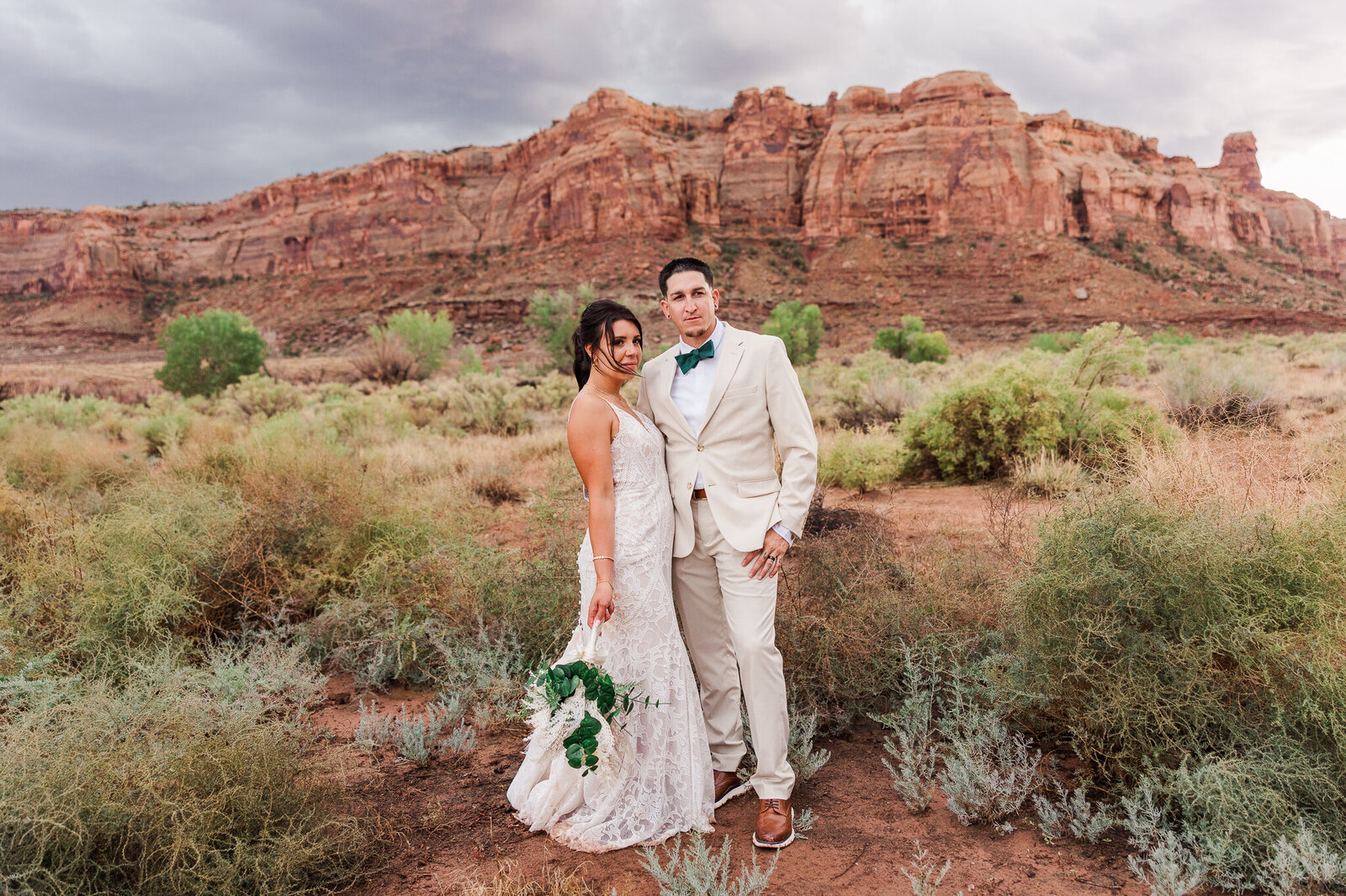 Bride and groom during sunset with Utah mountains in the background