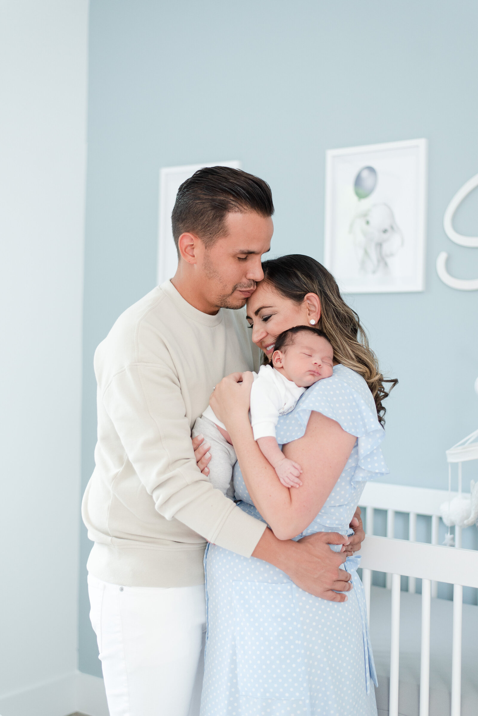 mom dad and newborn baby boy session in blue animal themed nursery in doral fl by Miami Lifestyle Photographers David and Meivys of MSP Photography