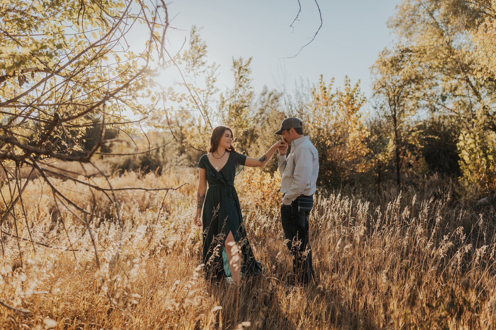 couple shares a kiss during golden hour