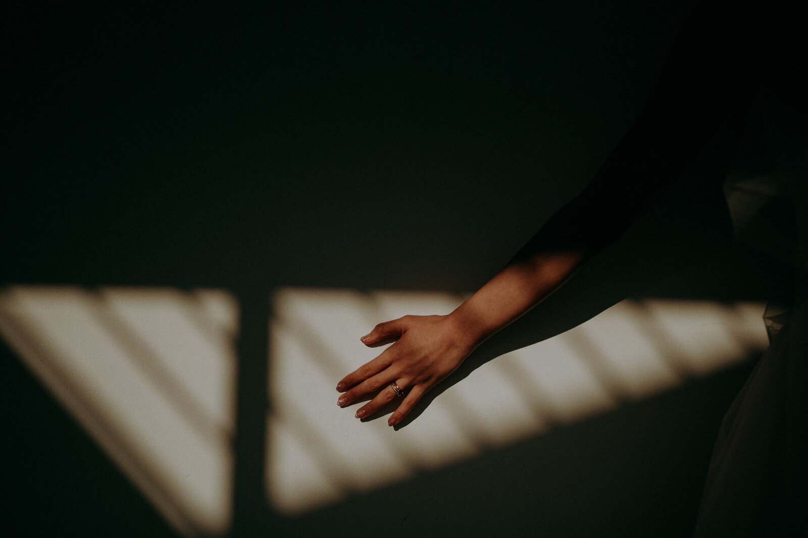 bride's hand on wall