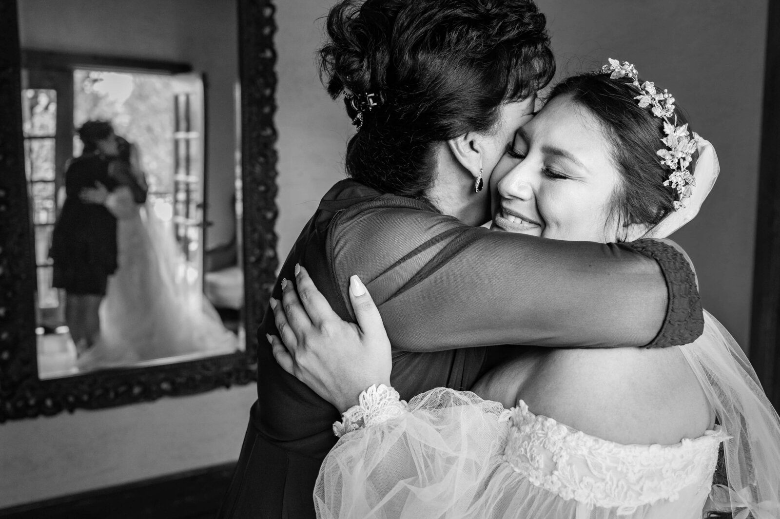 Bride and her mom sharing a big hug and emotional moment during getting ready on the wedding day.