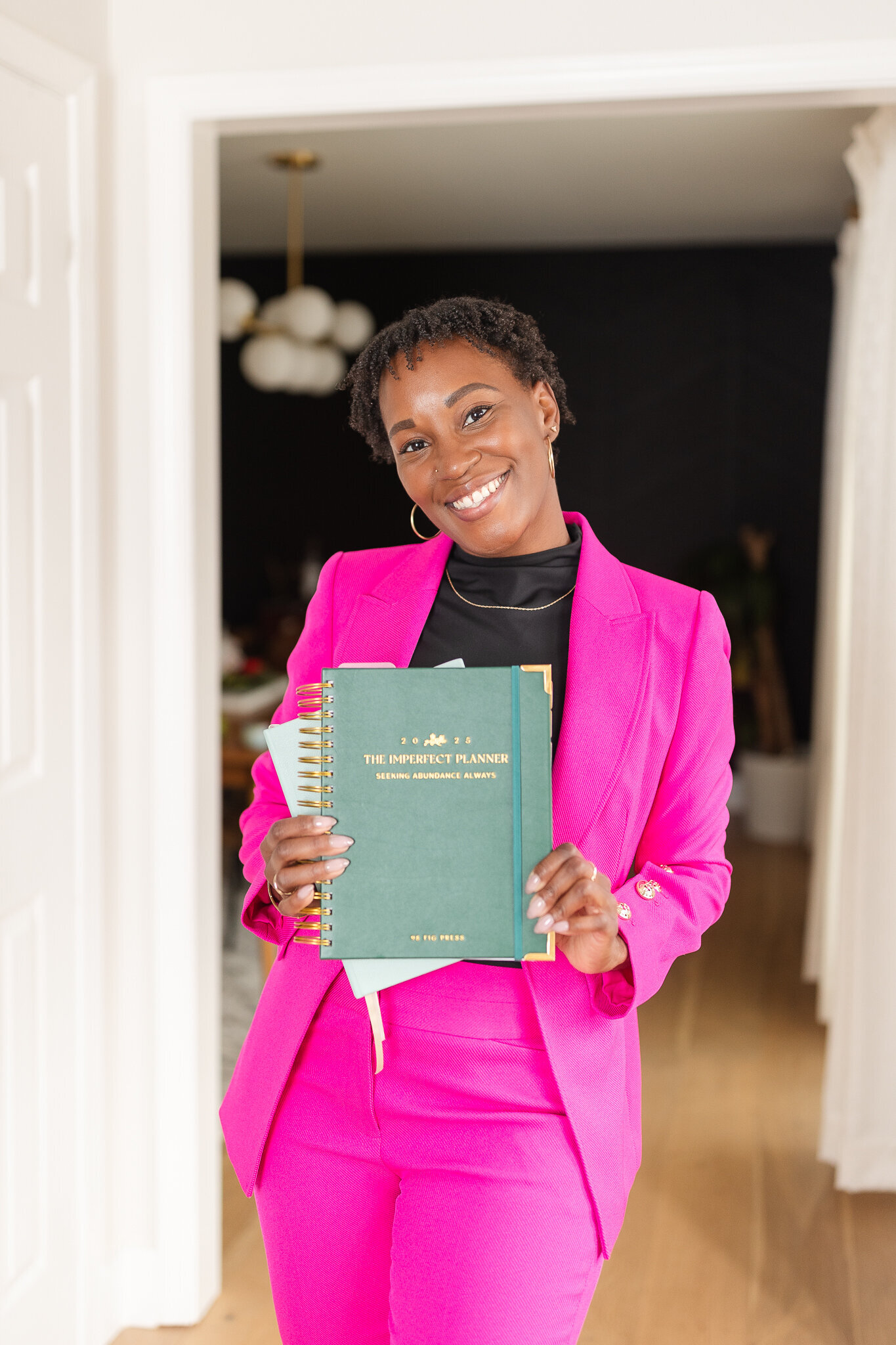 a woman holds the planners she designed