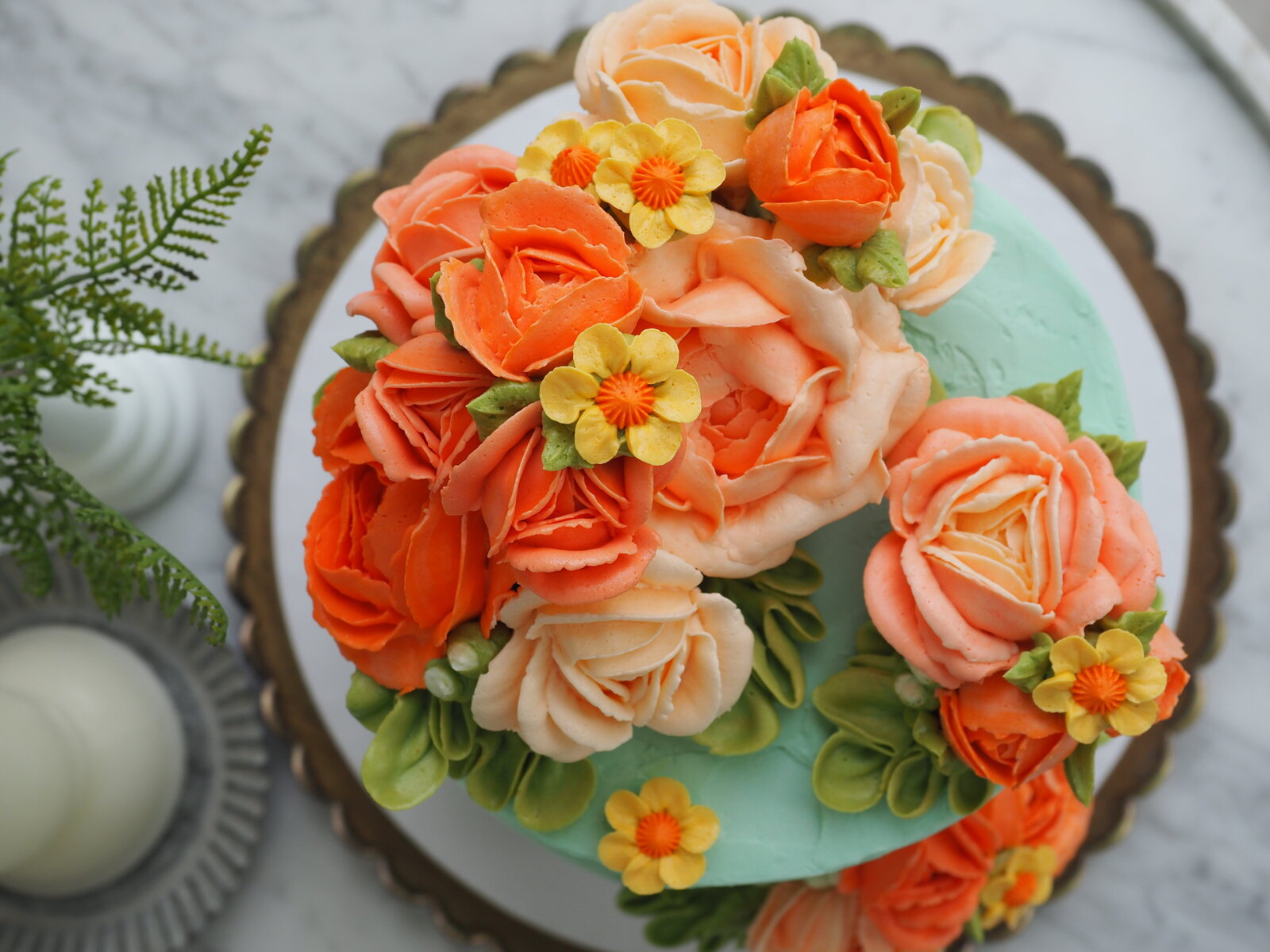 Top view of a floral buttercream cake with large flowers