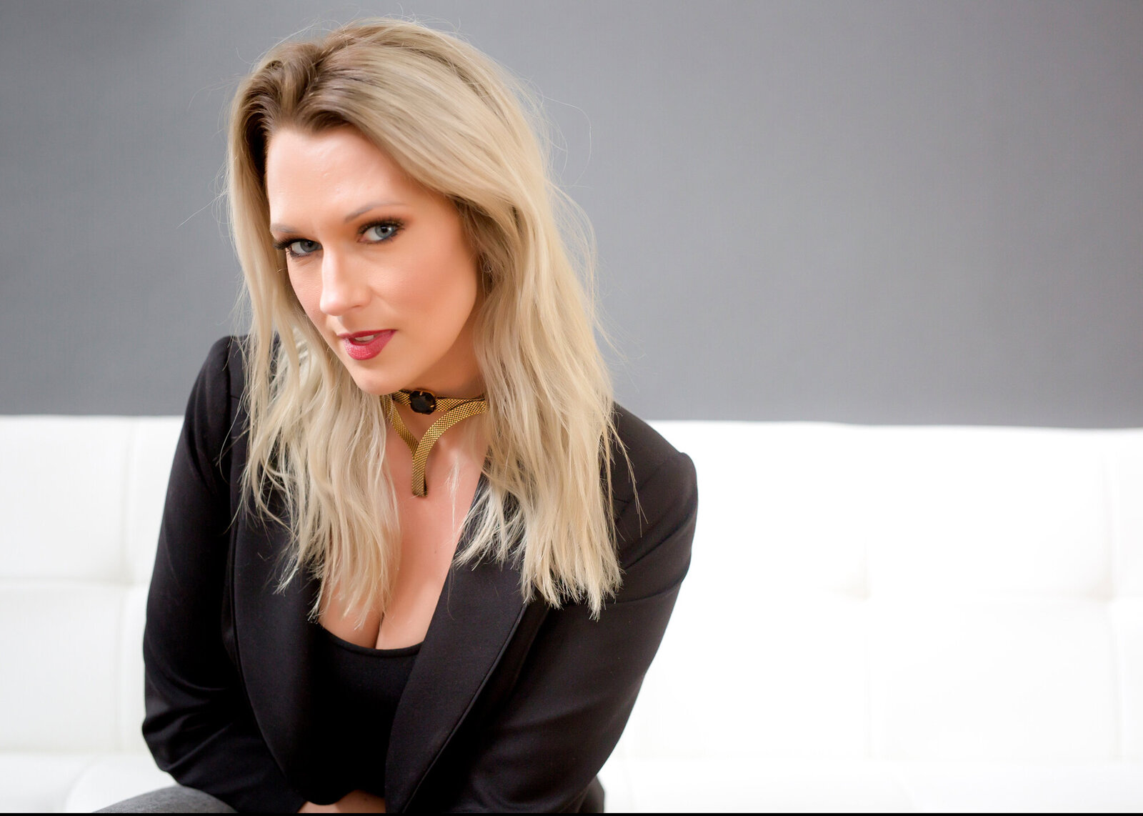 Fashion style headshot of a blonde female wearing black posing for a Barnstable County Portrait Photographer