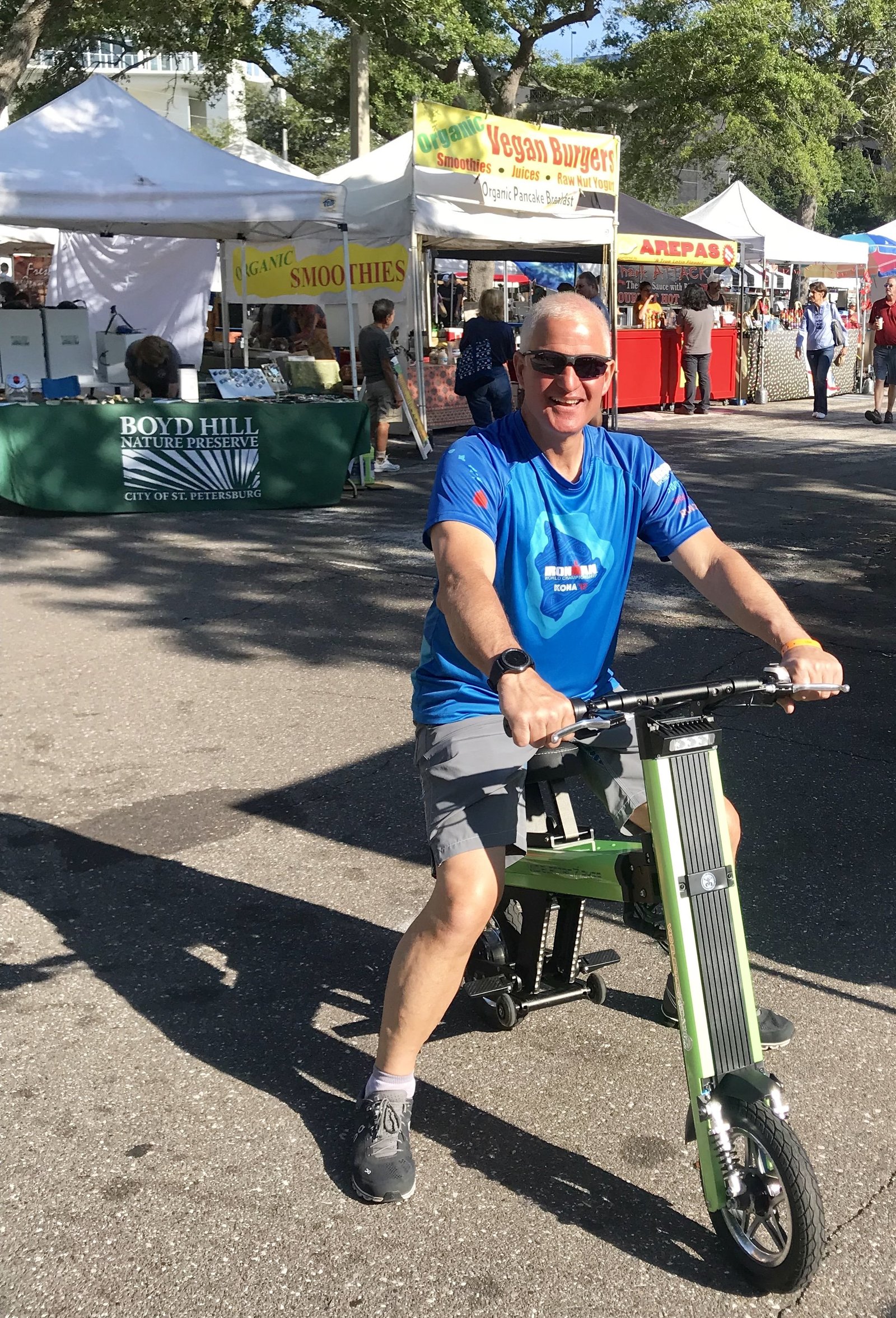 Man riding Green Go-Bike M2 to farmers market