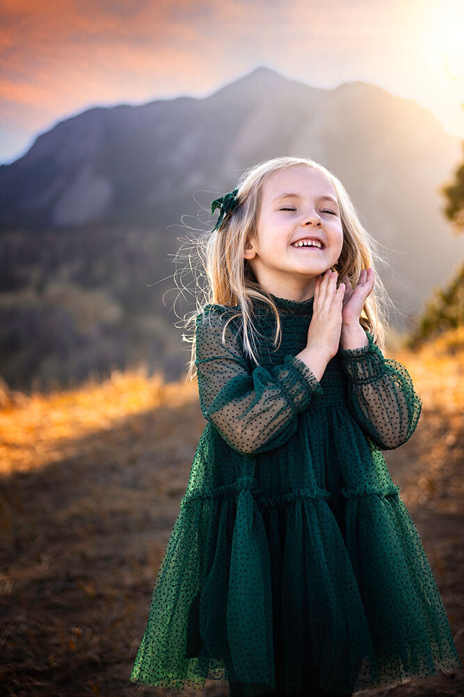 adorable-young-girl-genuine-relaxed-smile-joy-personality-sound-of-music-mountian-hill-top-colorado-boulder-NCAR-forest-green-boutique-dress