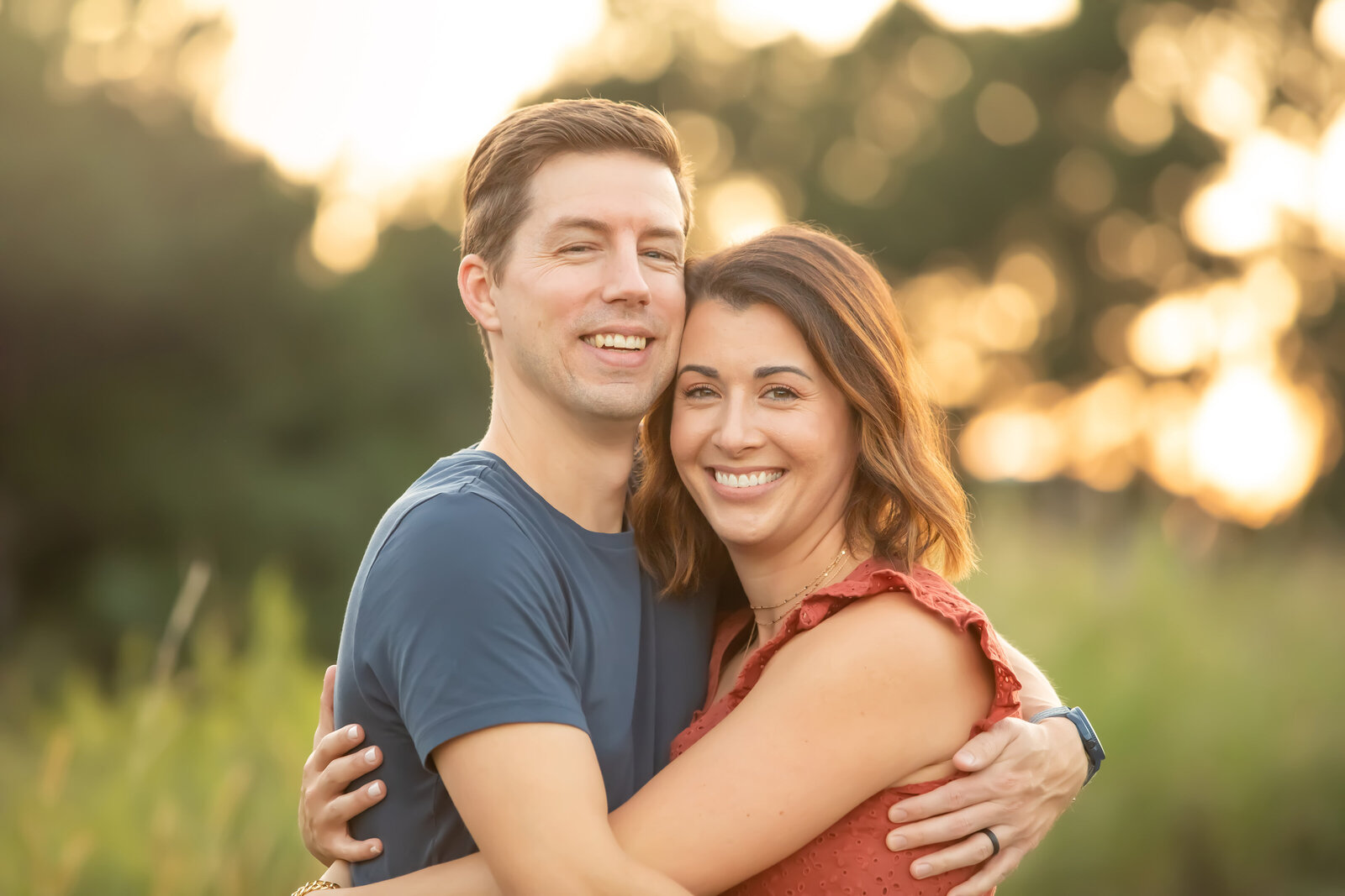 Wife and Husband hugging during family portraits in Raleigh, NC.