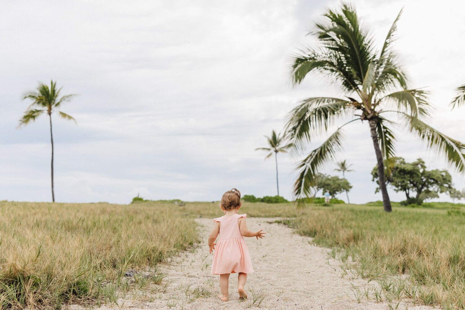 baby walking to beach