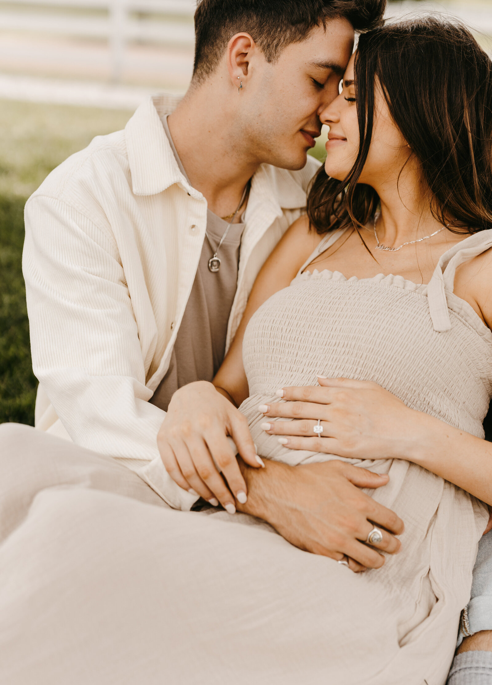 Jess and Gabriel Conte laying in a field