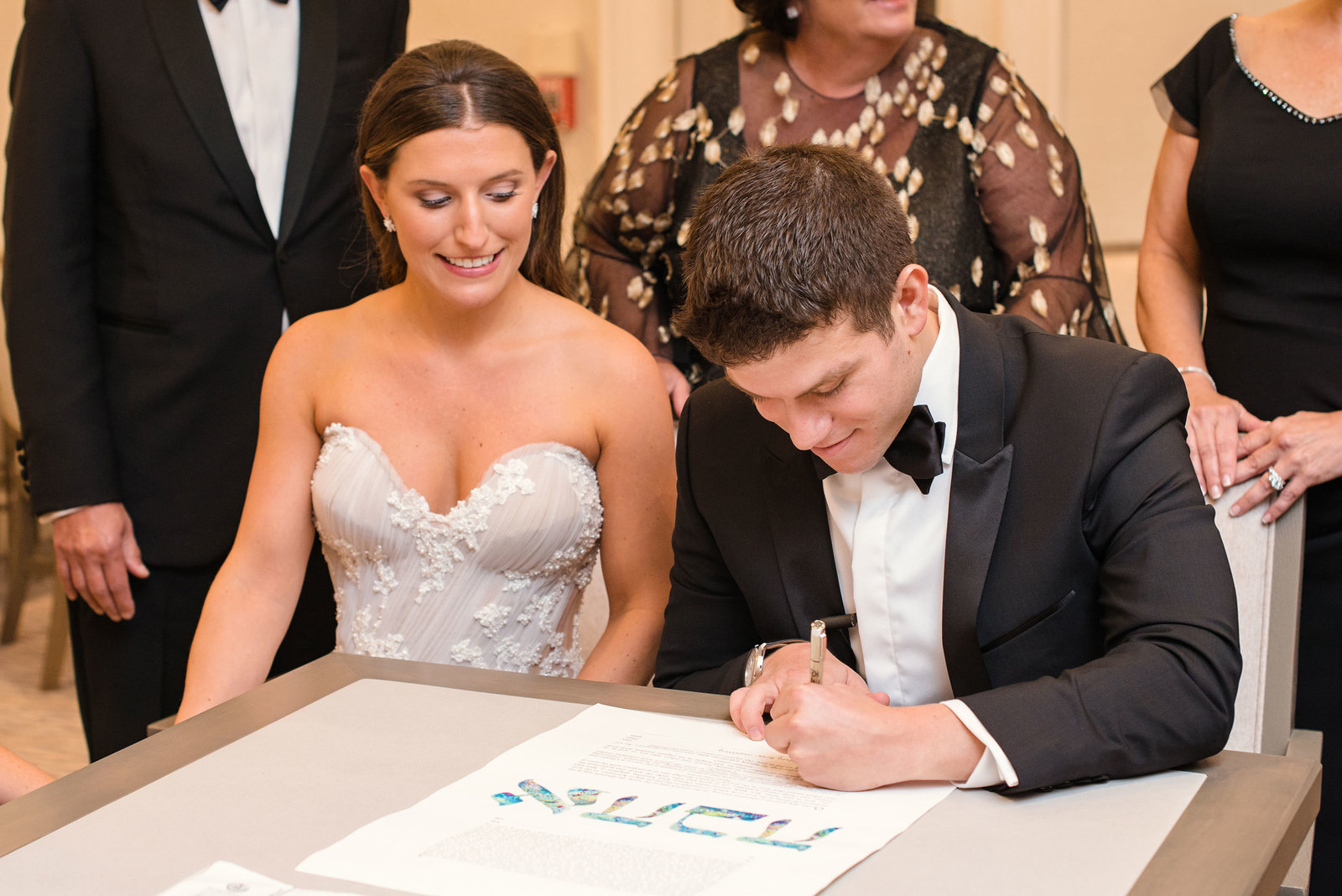groom signing the ketubah at Glen Head Country Club