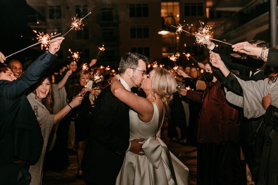 bride and groom kissing sparkler exit photo ideas during nighttime beach wedding in delaware