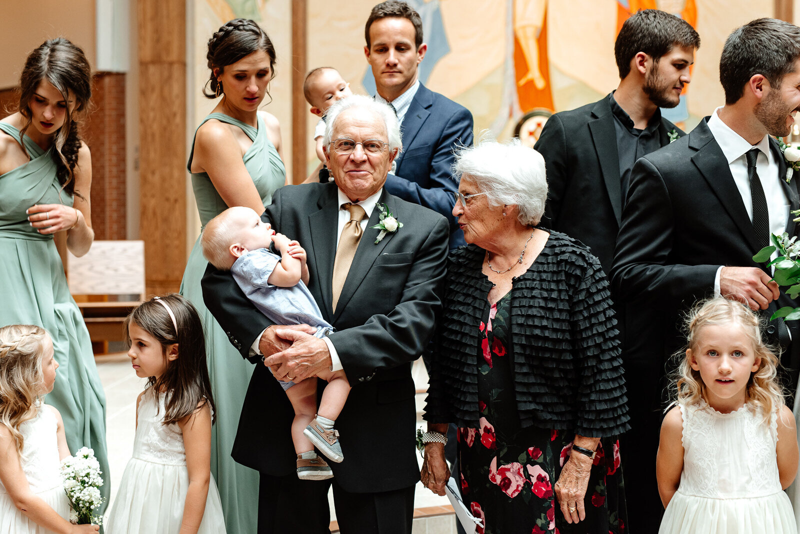 great grandparents holding baby at the wedding