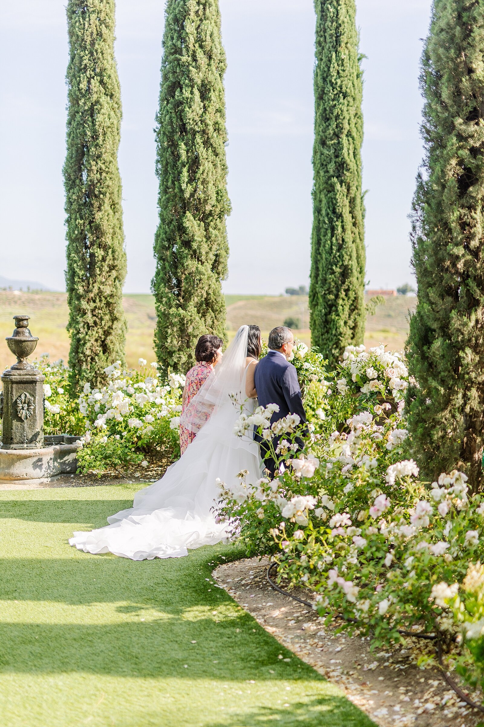 Bride walking with her parents down the aisle at Monserate Winery in Temecula.