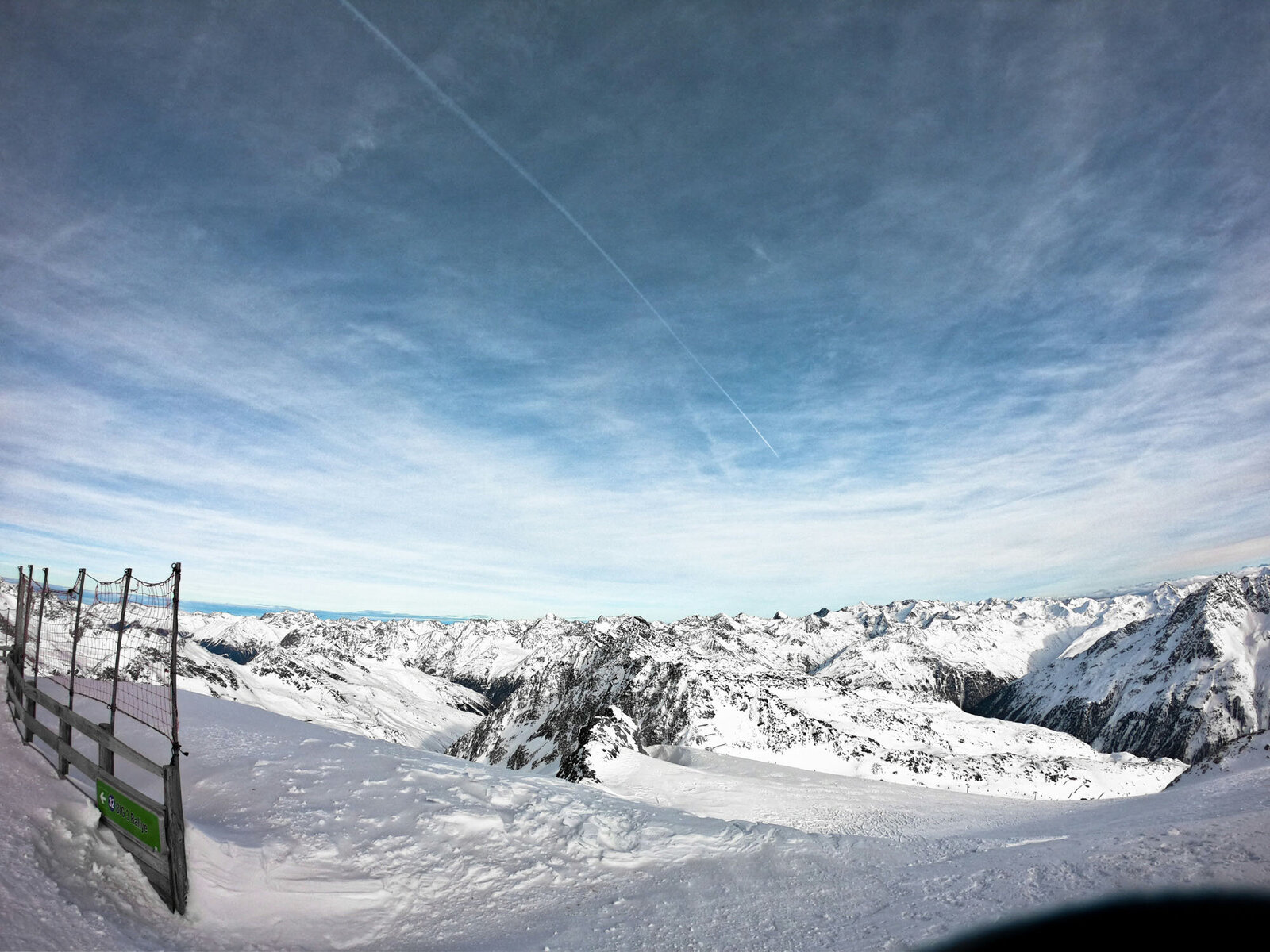 A snowy mountain with a blue sky in the background