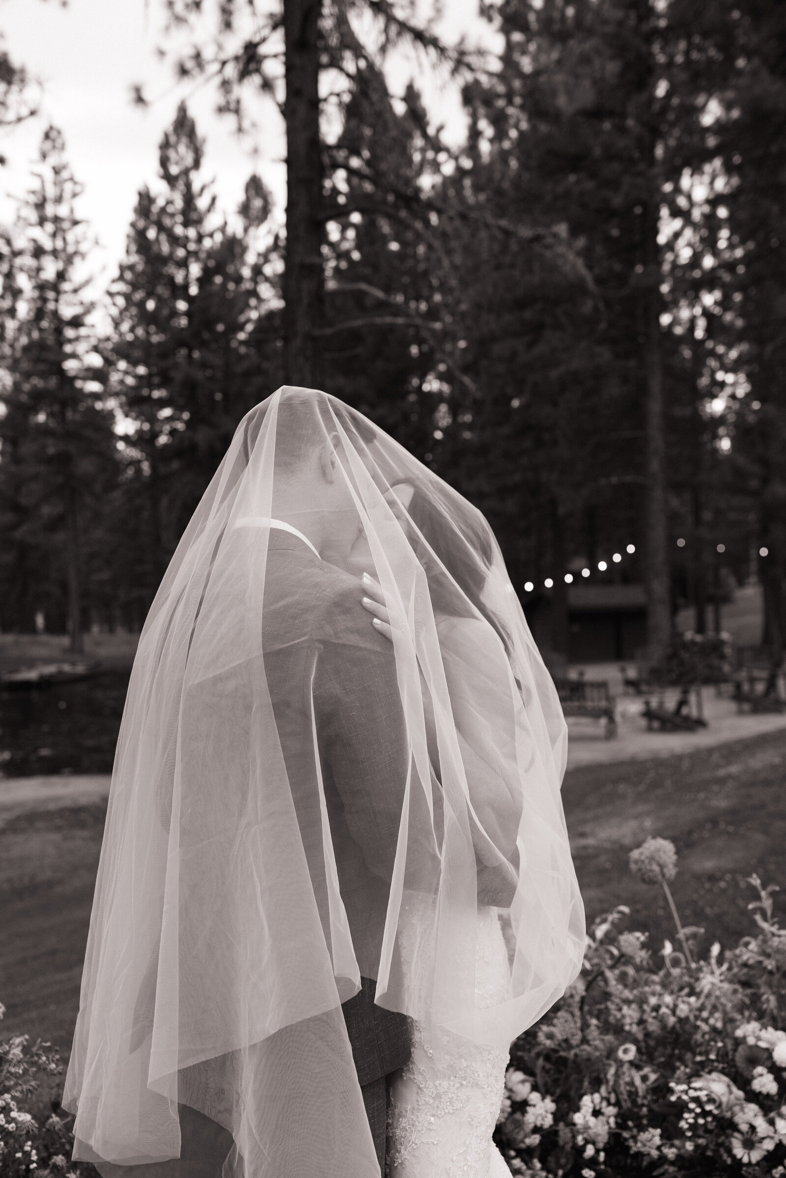 Bride and groom kiss under veil during bridal portraits in Tahoe