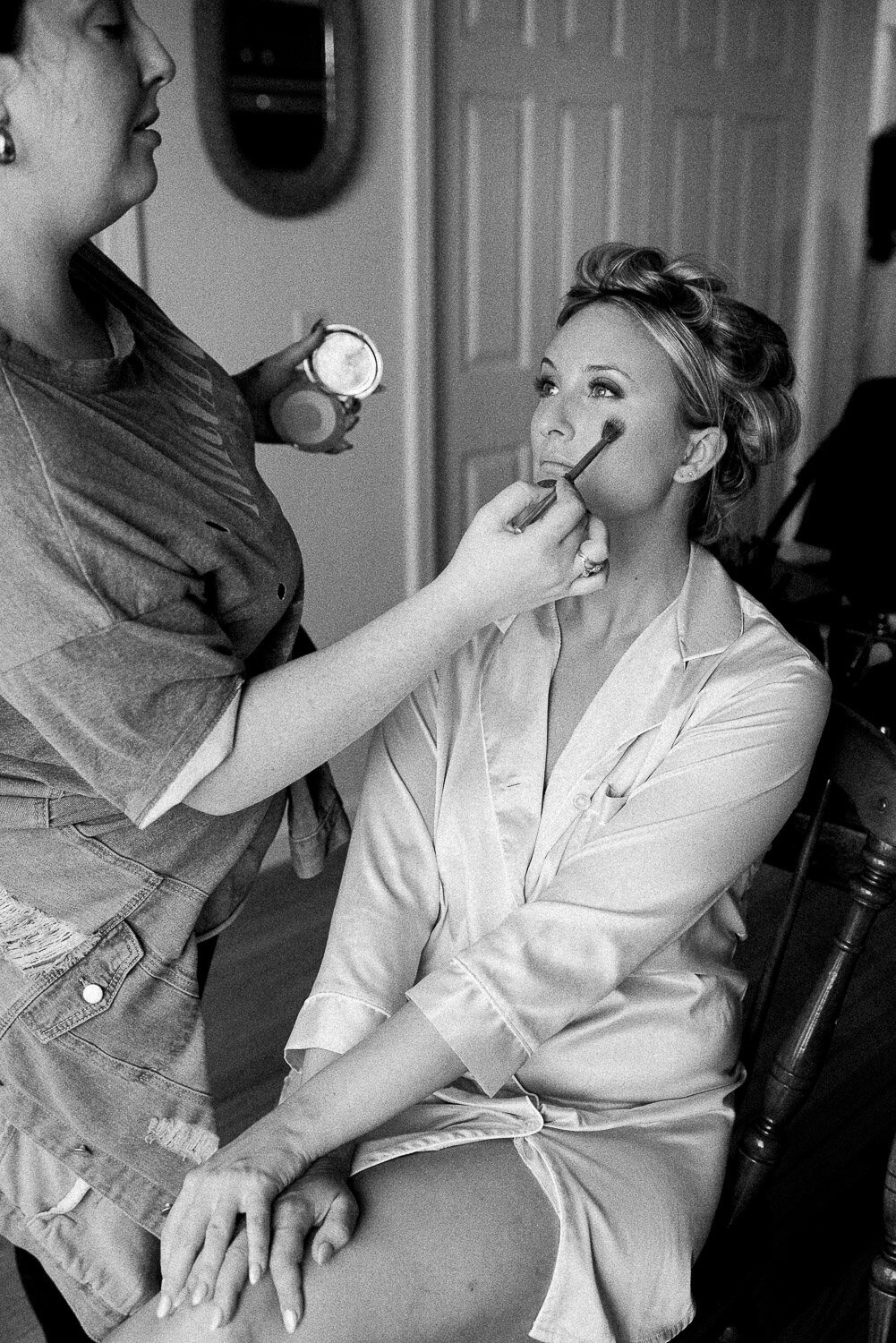 bride in robe getting  blush done