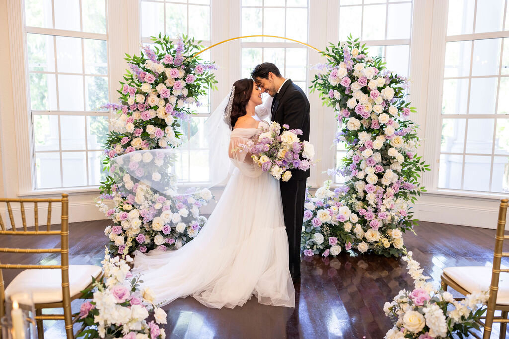 Celebrate your love at a prestigious Central Florida estate with a stunning indoor ceremony. Silk floral displays and grand wedding arch create a picture-perfect, luxurious setting