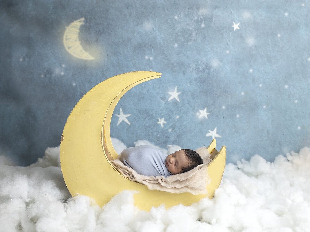 Newborn boy posed on the moon.