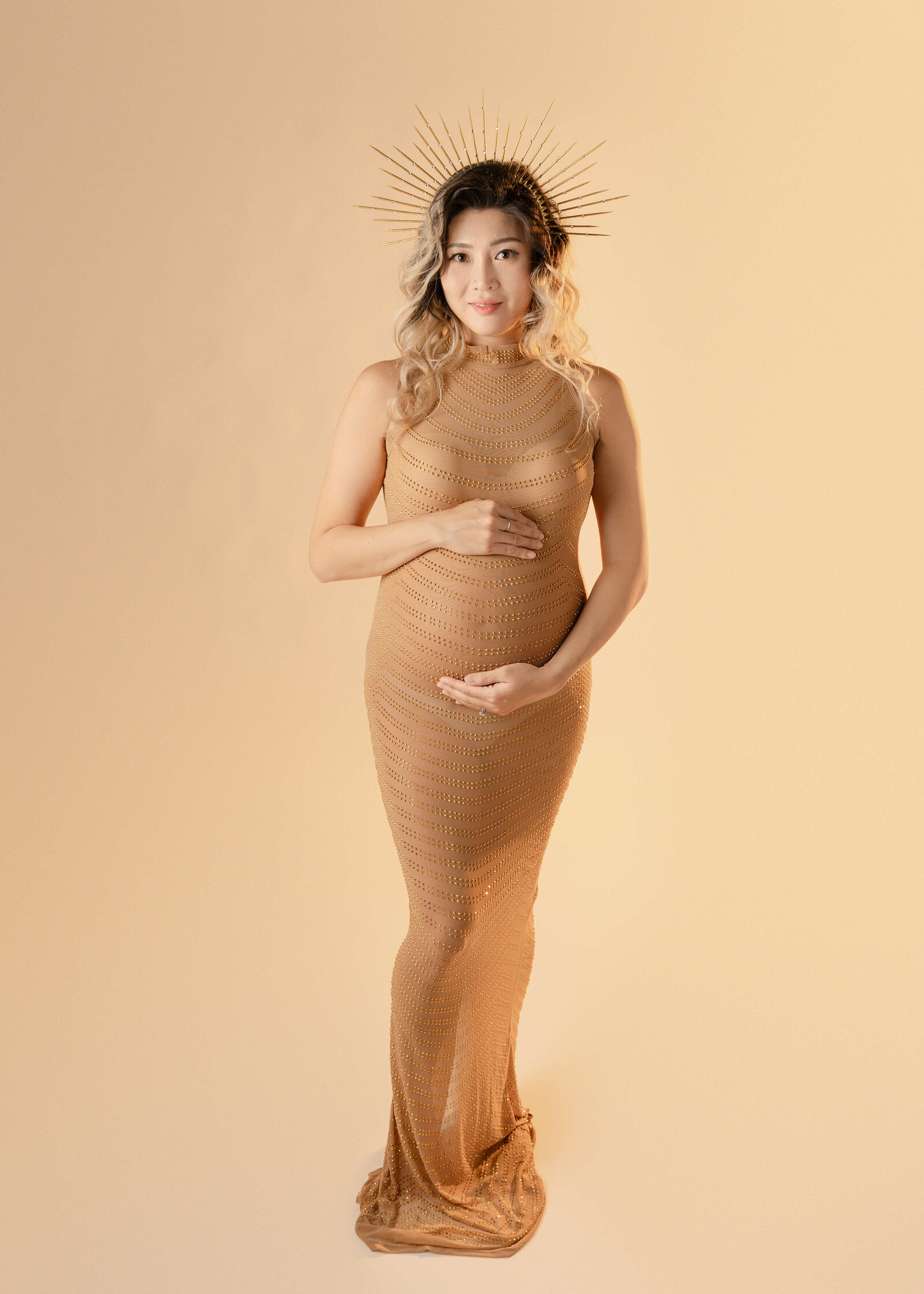 Mom wearing goddess crown and dress  in studio by Ashley Nicole.