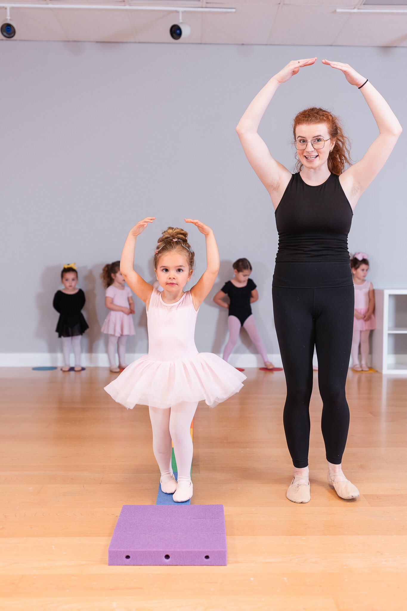 a teacher demonstrates next to their student