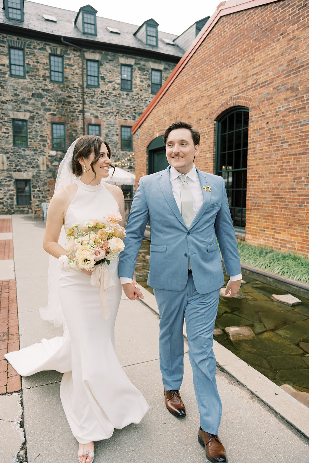 Bride and groom portrait walking outside the Washington mill dye house.