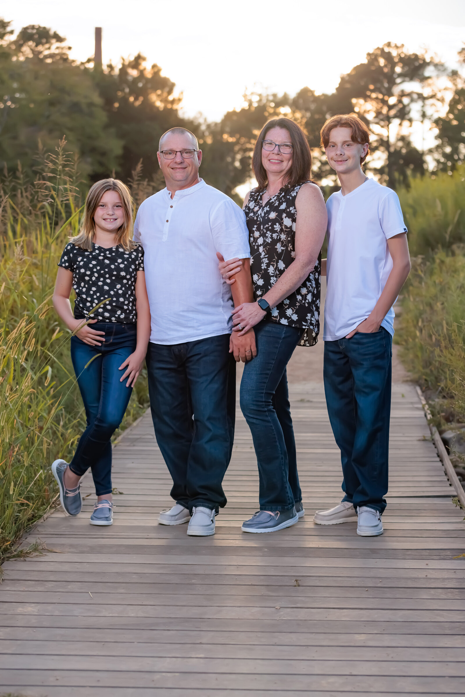 Family on a bridge at golden hour in Raleigh NC.