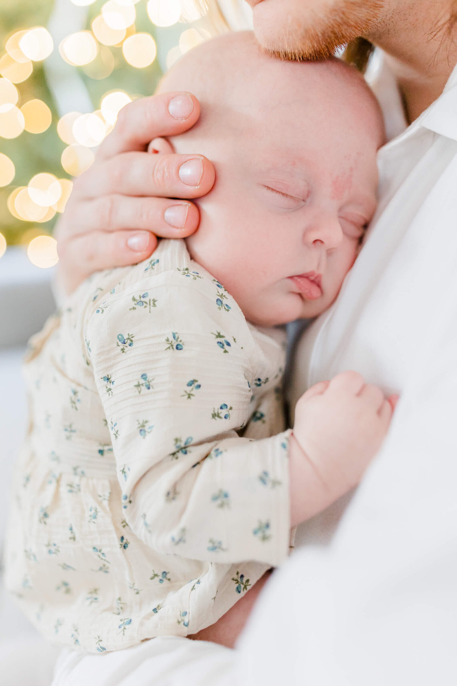 Newborn snuggles into her dad's chest