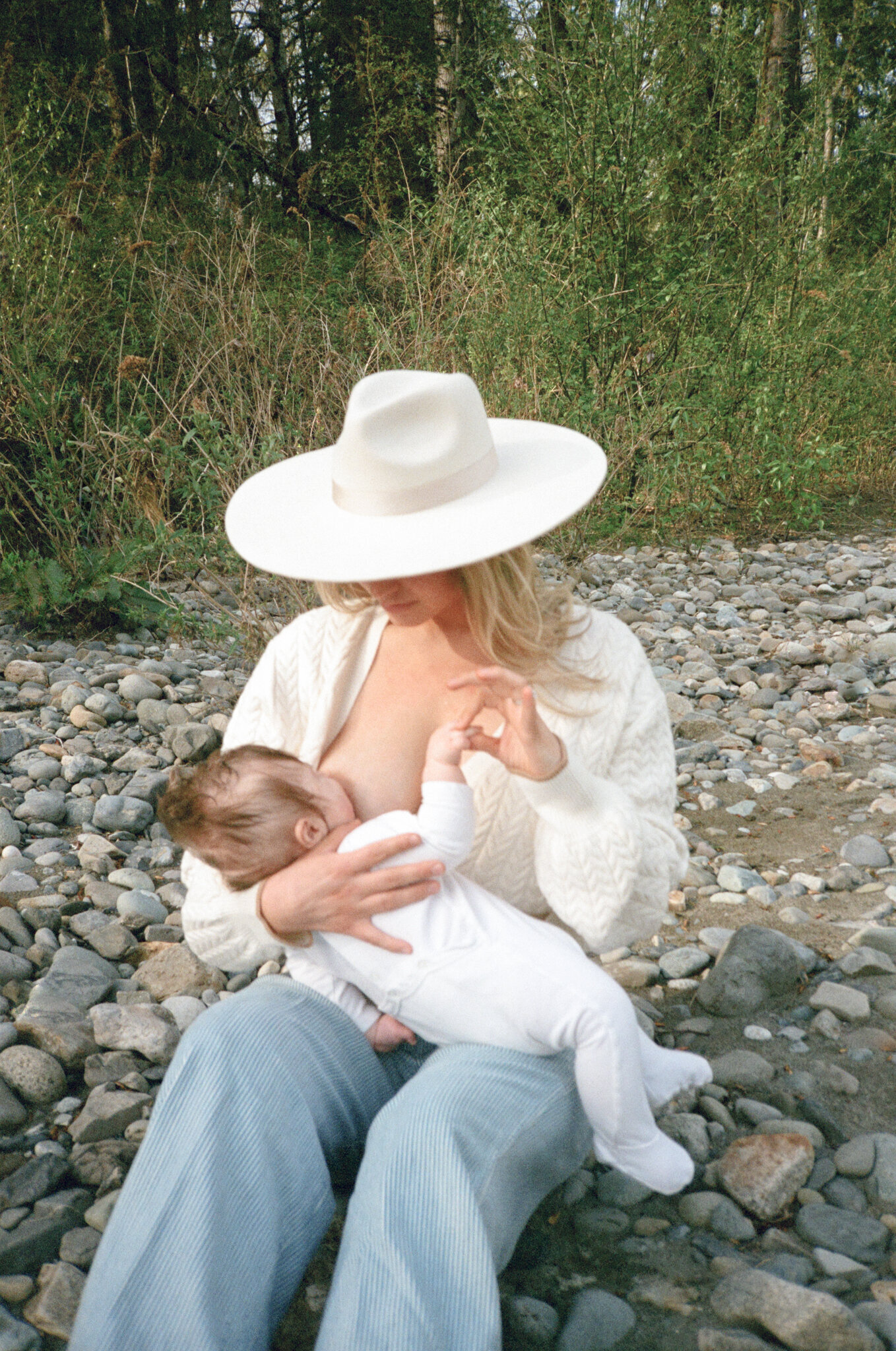 Mother breastfeeding child on film at the Williamette River in Portland, Oregon.