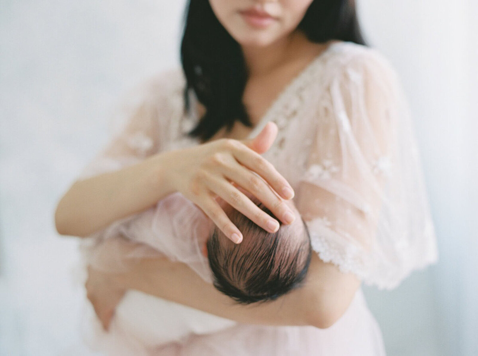 Mother holding newborn close up, Bay Area newborn photographer session.