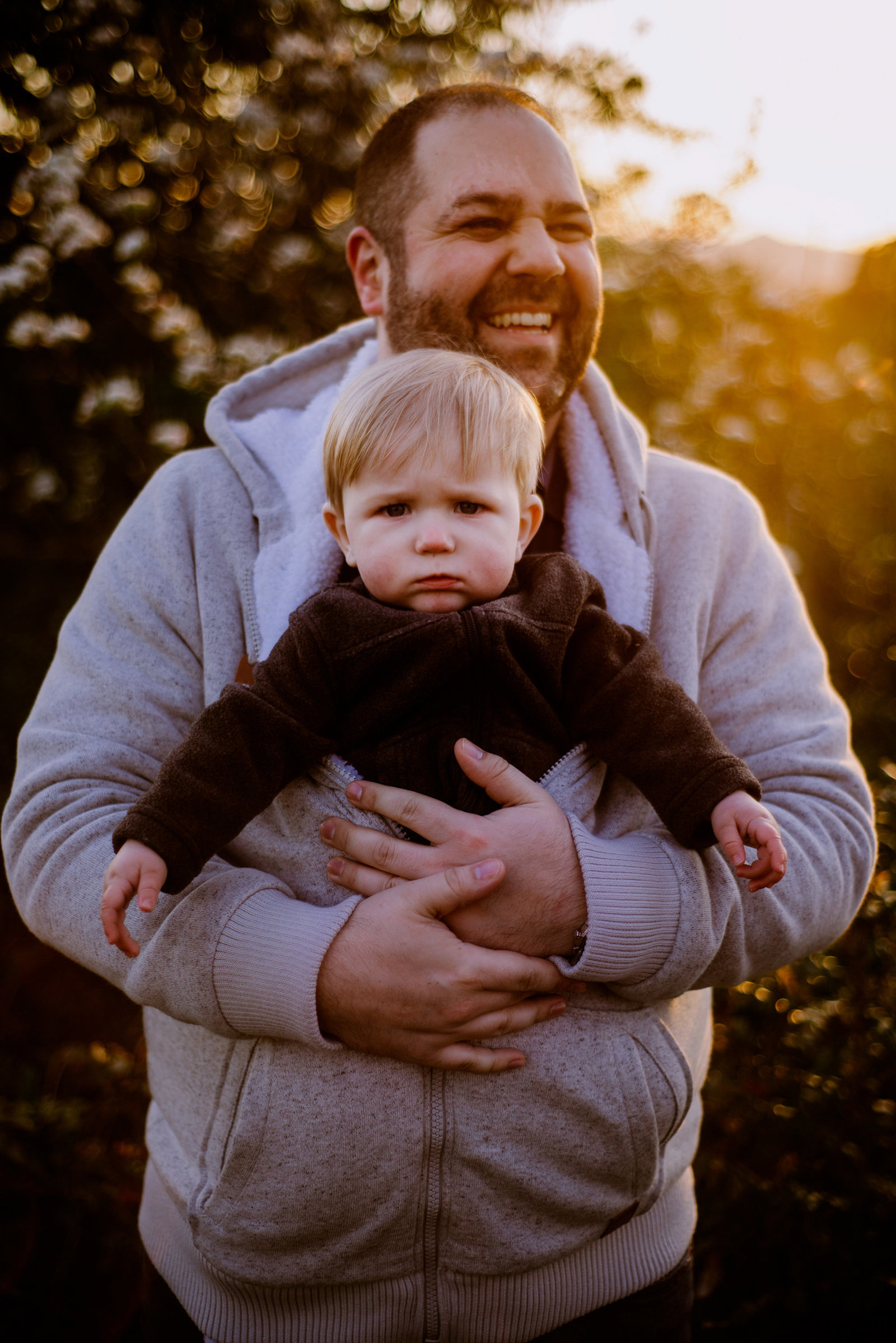 dad carrying his son at sunset at Discovery Park by Rooted and Wild Photography