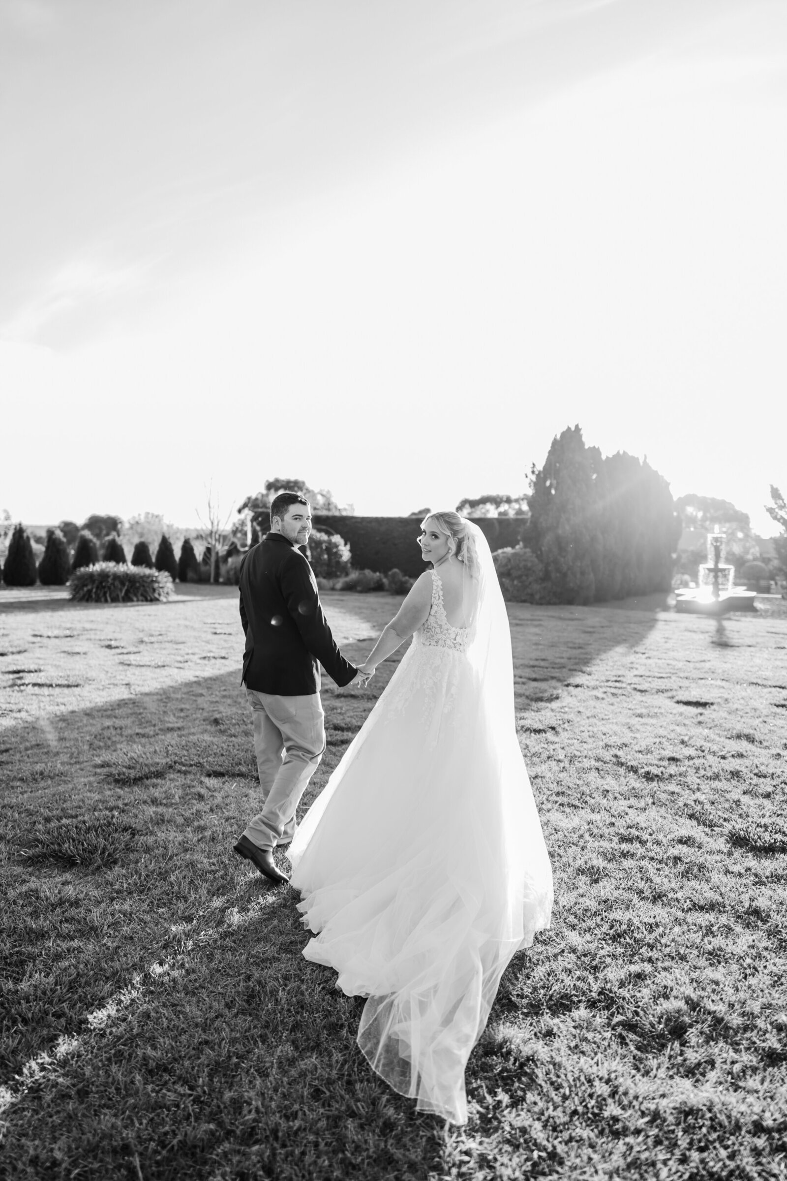 Bride na groom walking into the sunset on their wedding day