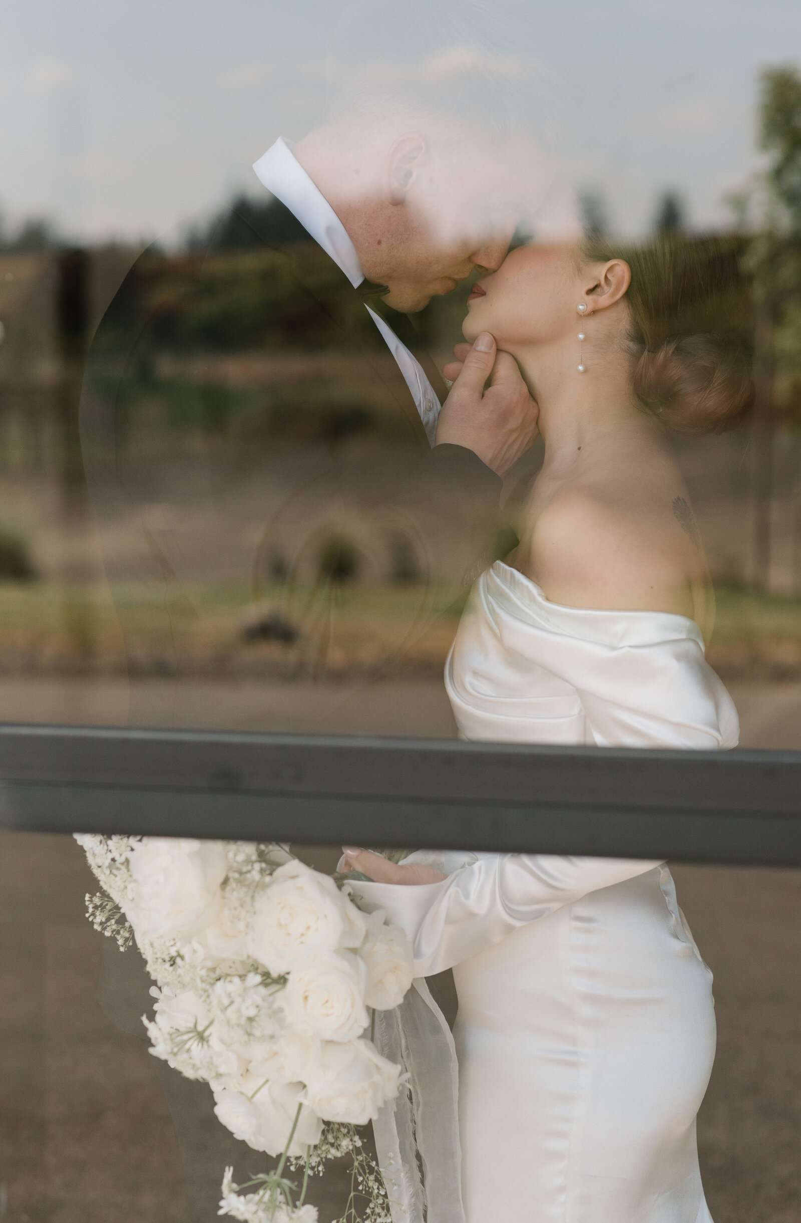bride and groom portrait through a window