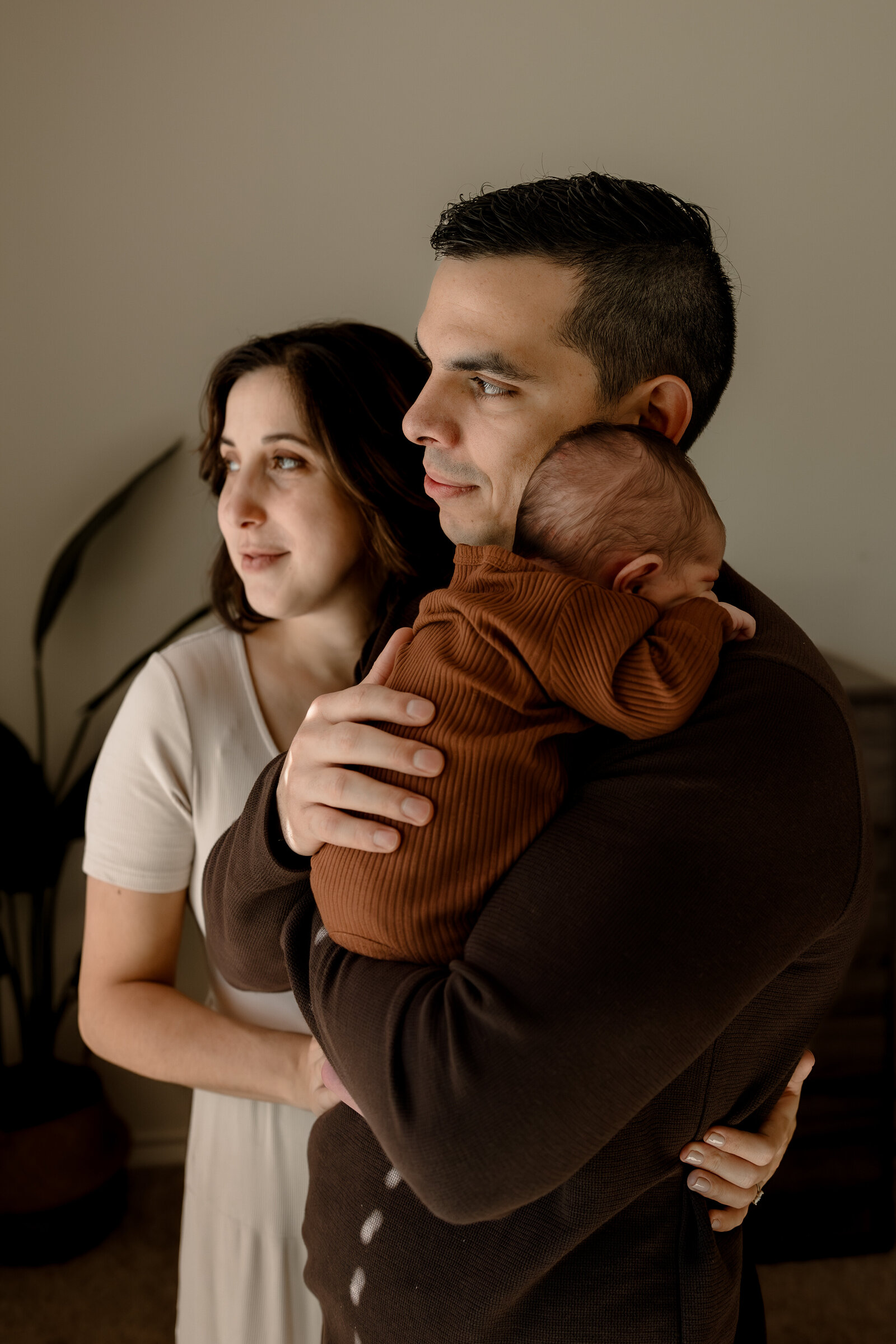mom and dad holding newborn