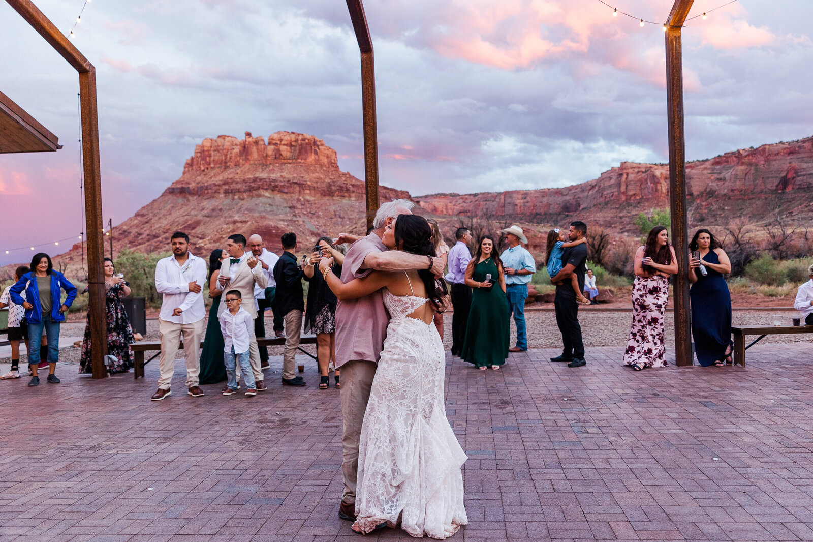 Brother gives his sister, the bride a big hug during sunset at her Utah Wedding